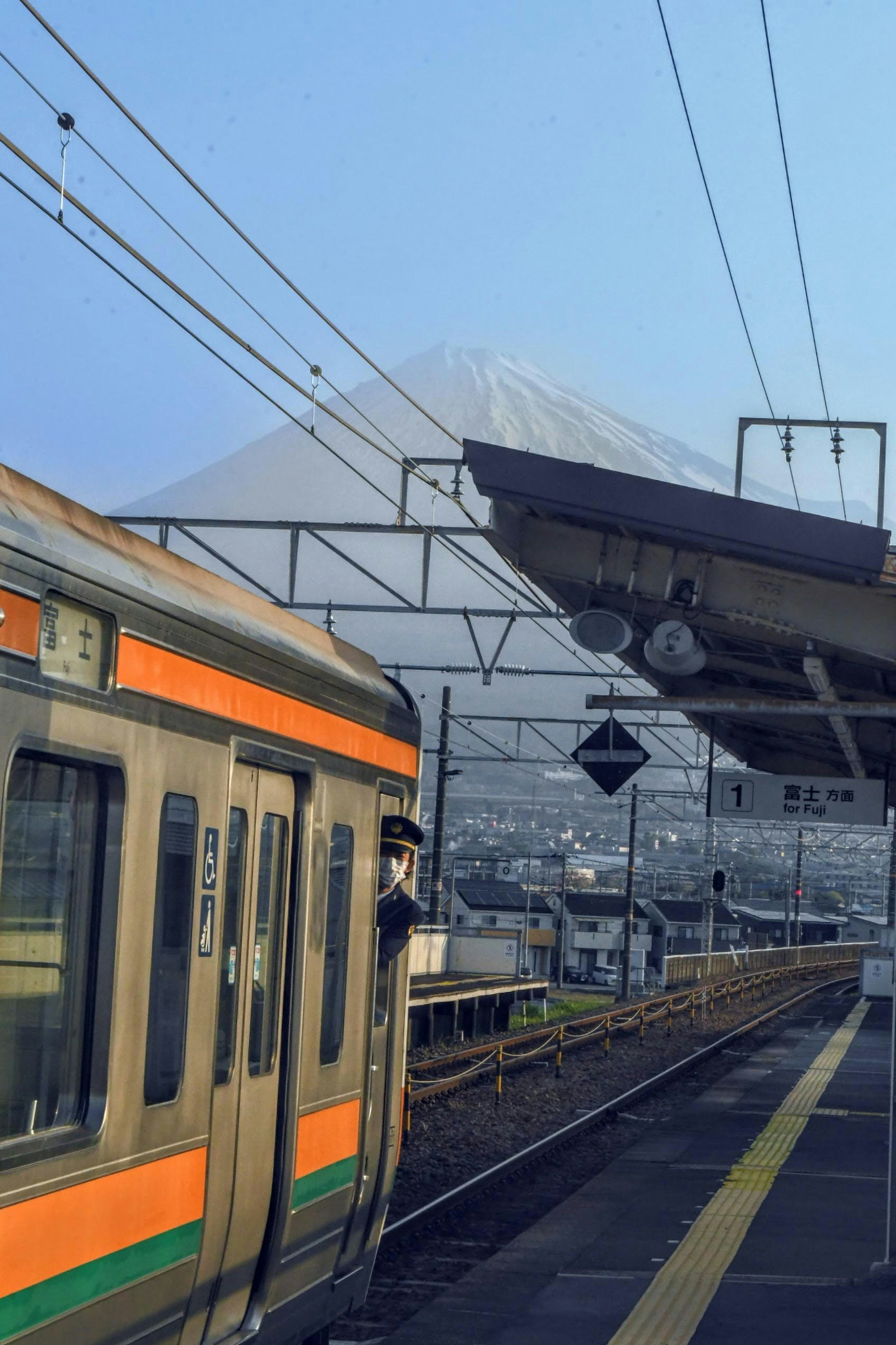 Train at a station with Mount Fuji in the background