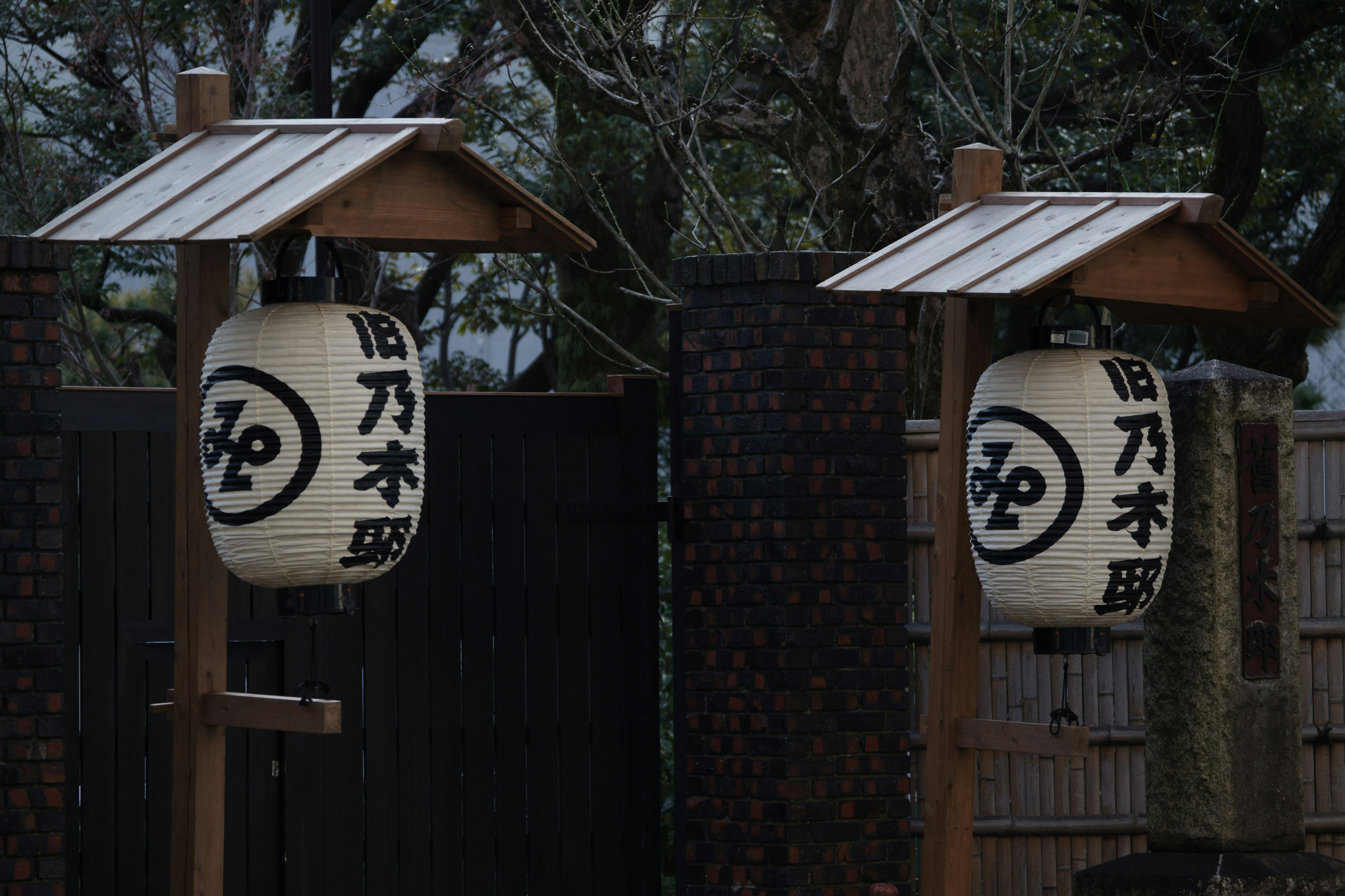 Two traditional Japanese lanterns displayed in a serene setting