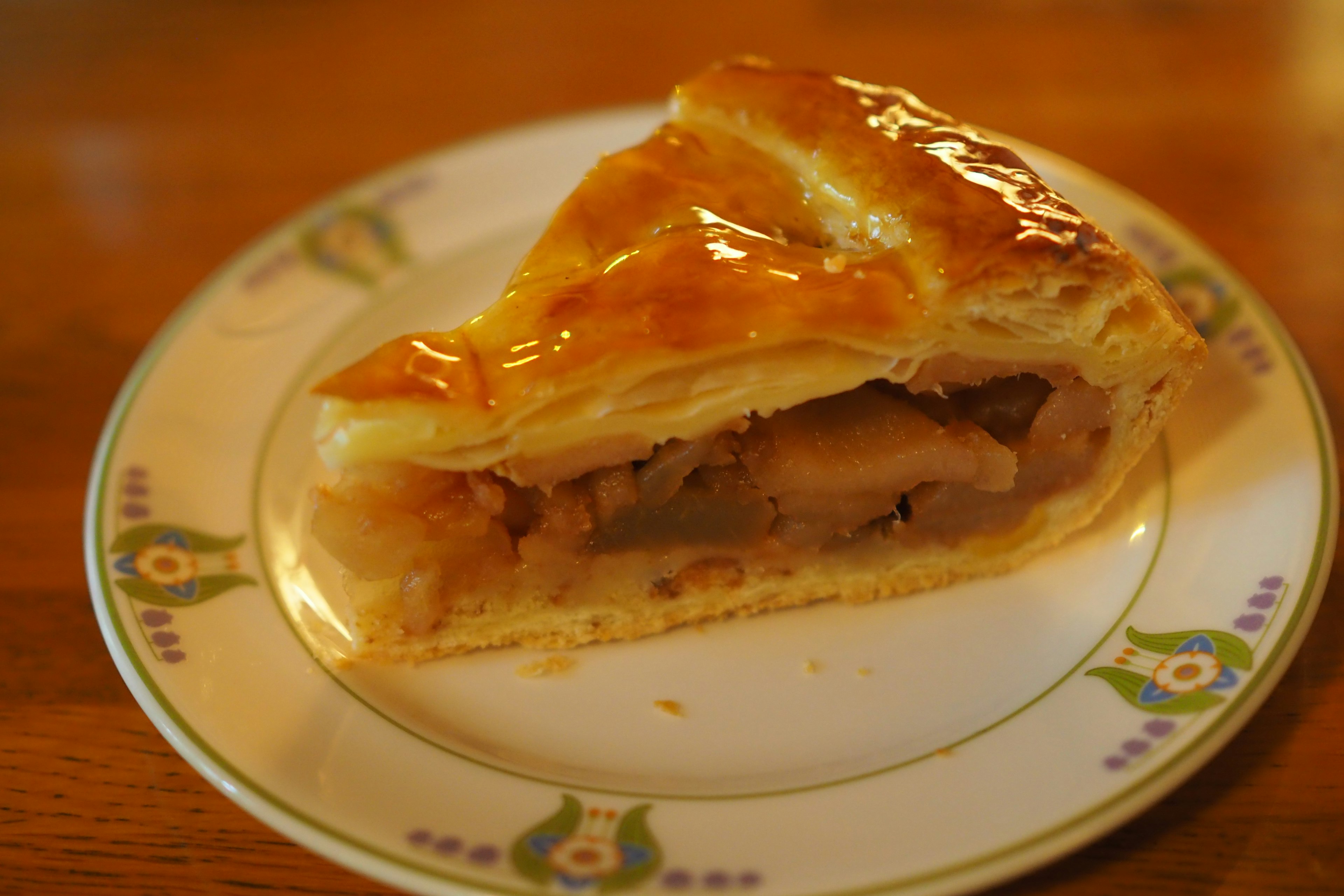 A delicious slice of apple pie displayed on a decorative plate