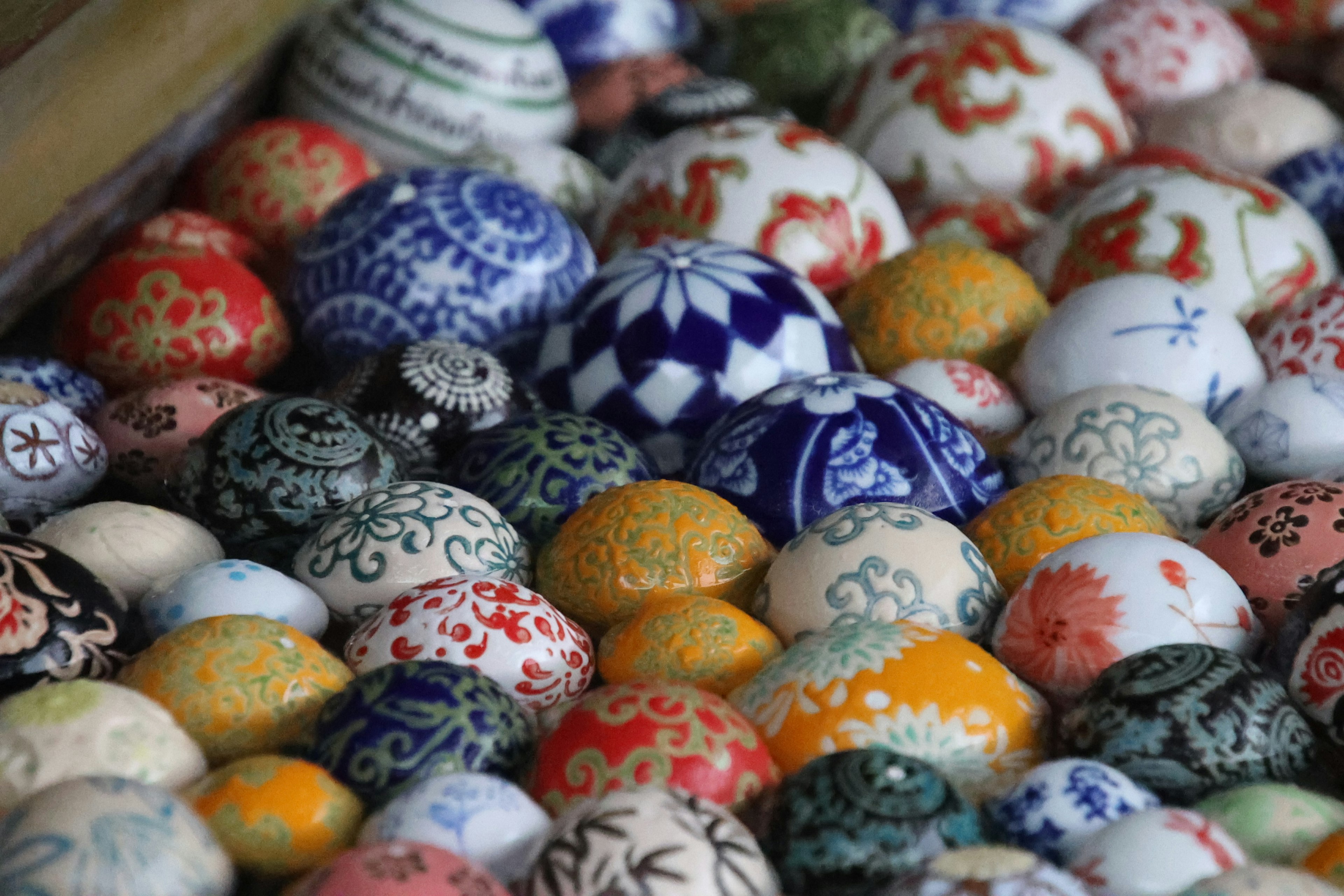 A collection of colorful decorated eggs arranged closely together