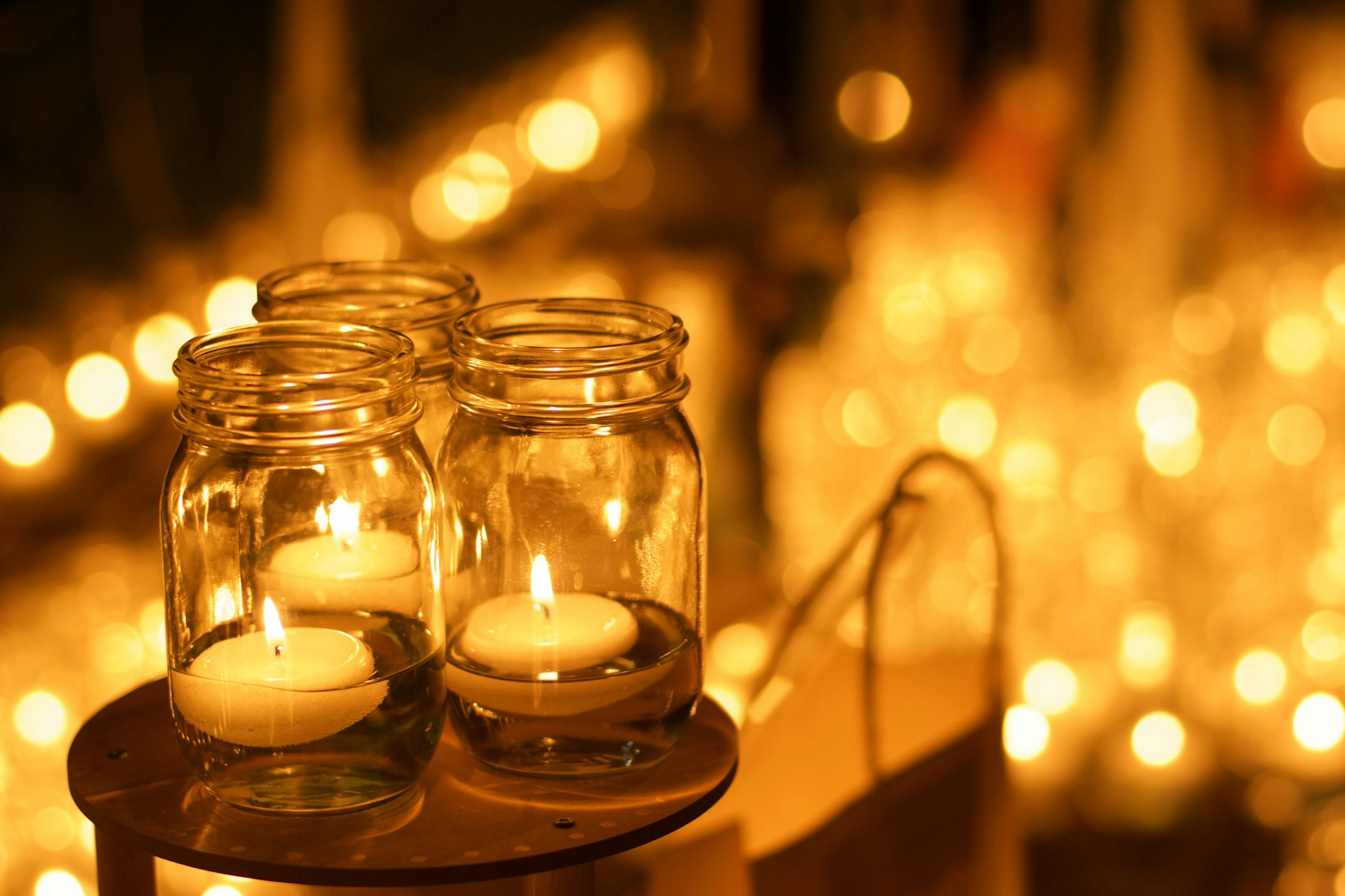 Warm scene with glass jars containing candles