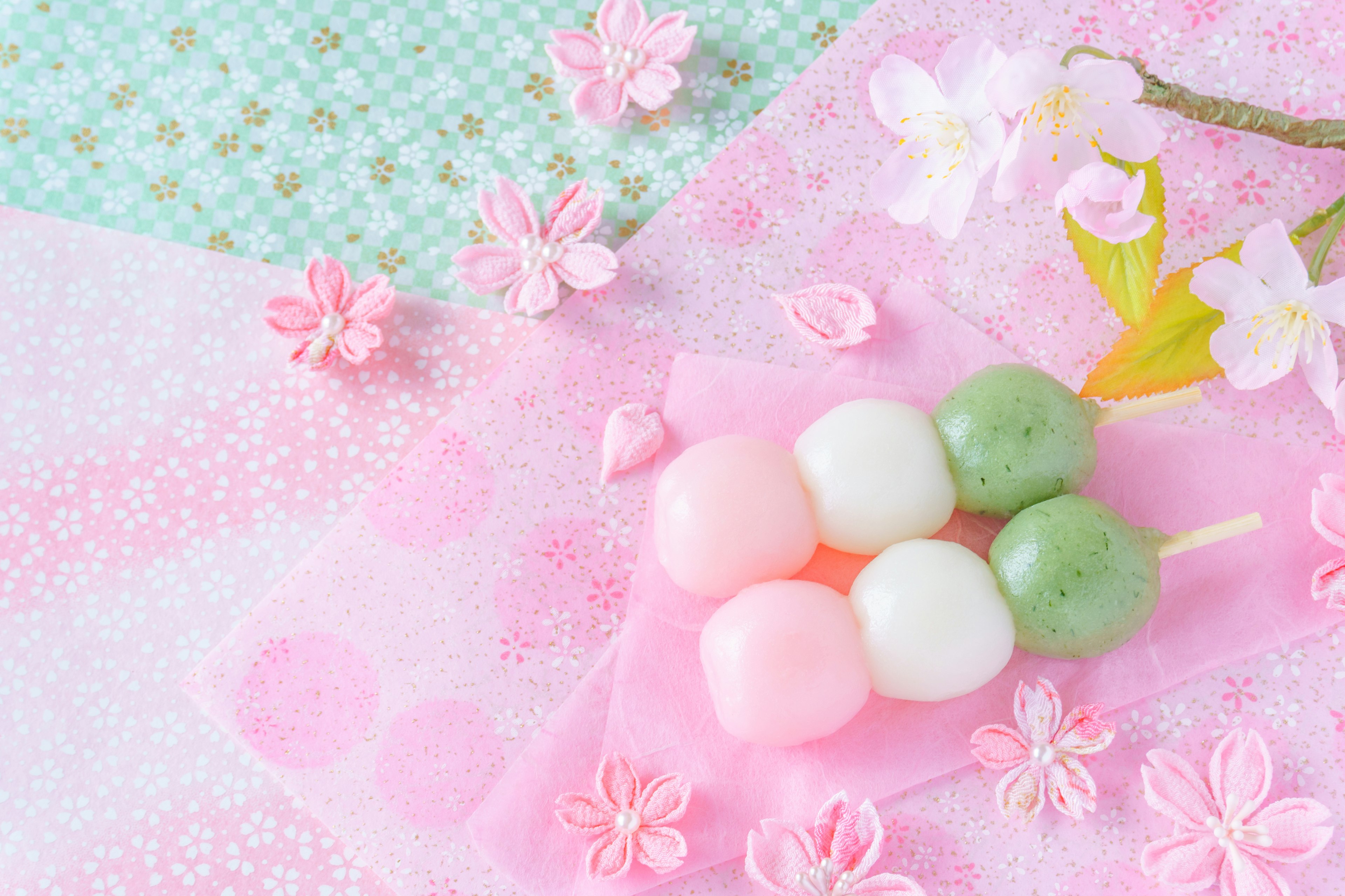 Colorful dango with cherry blossoms in a spring-themed setting