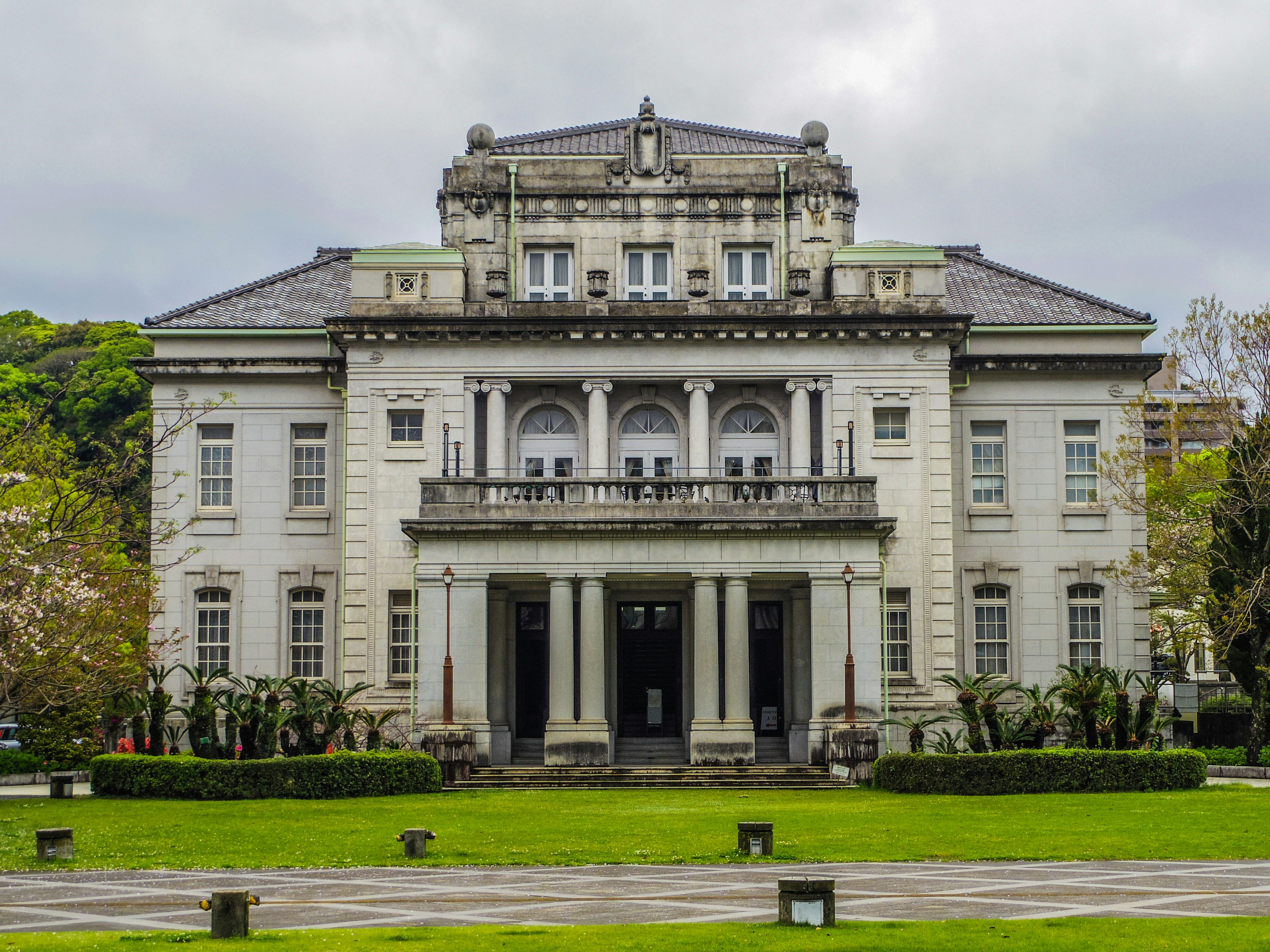 Historic building exterior large white mansion surrounded by a beautiful garden