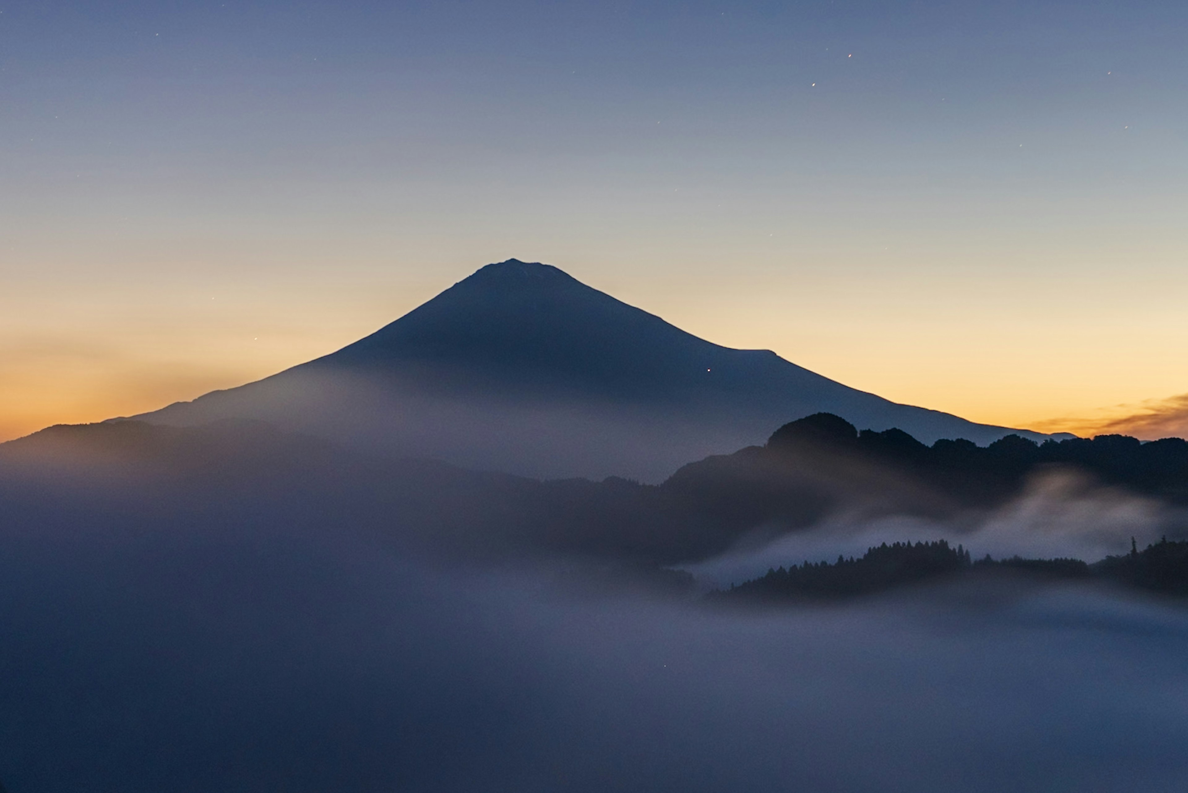 Mount Fuji at dawn with misty landscape