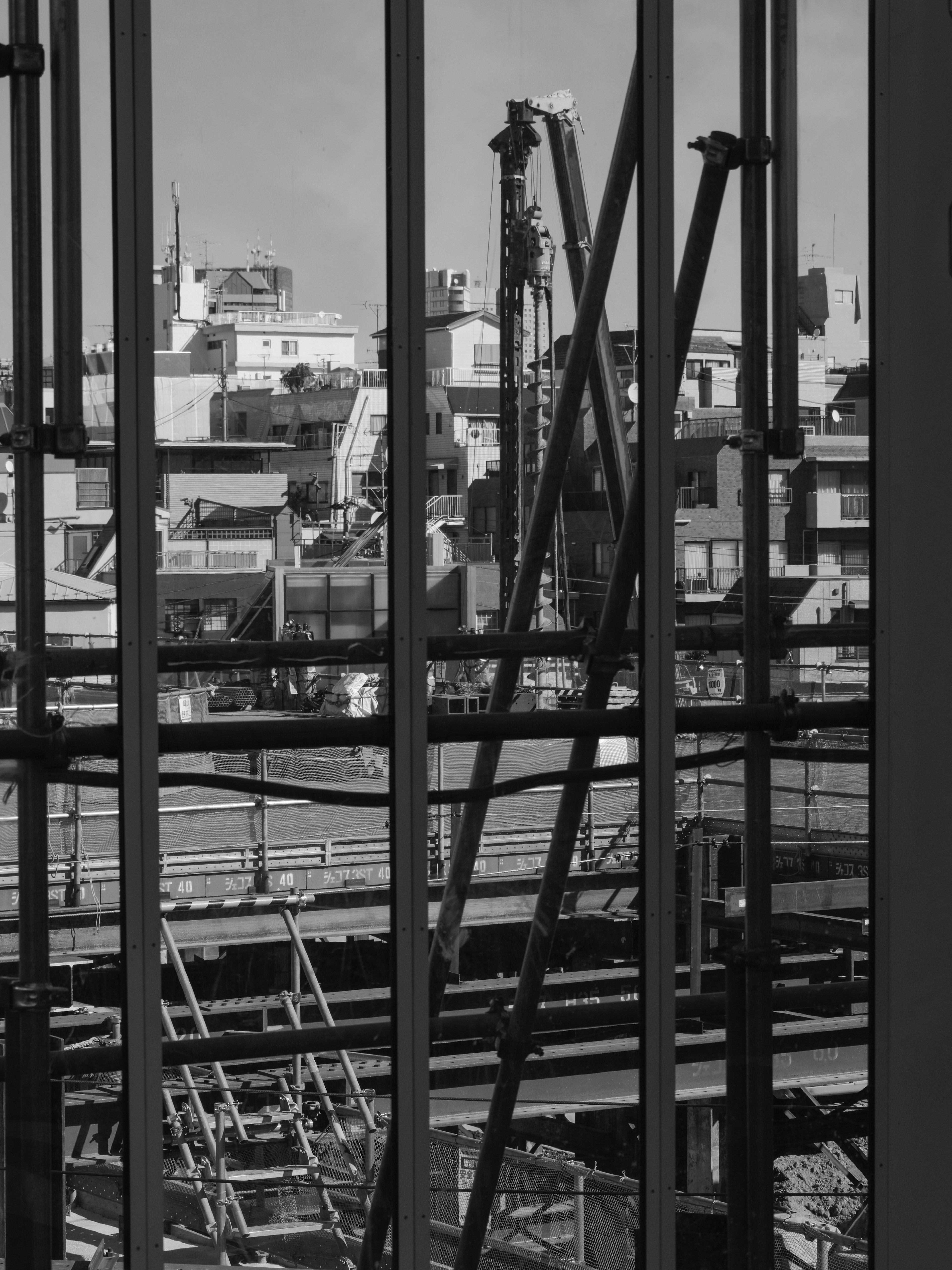 Construction site visible through building glass with steel framework