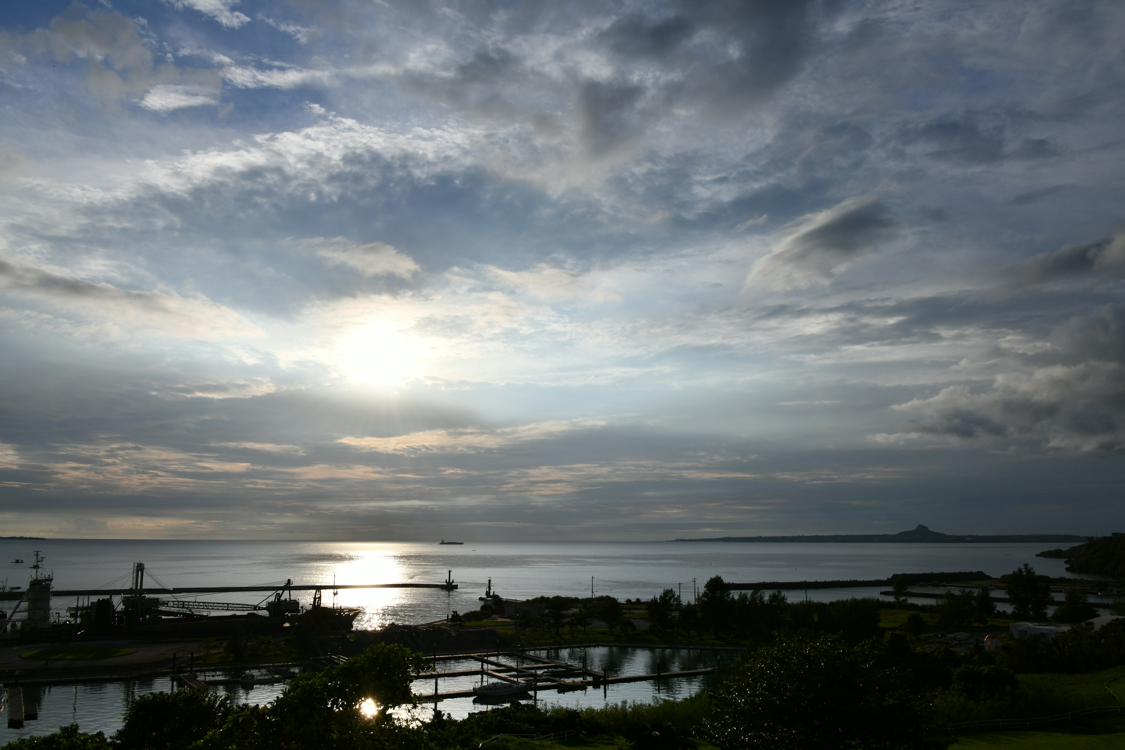 Schöne Landschaft mit Wolken und Sonnenuntergang, der sich auf dem Meer spiegelt