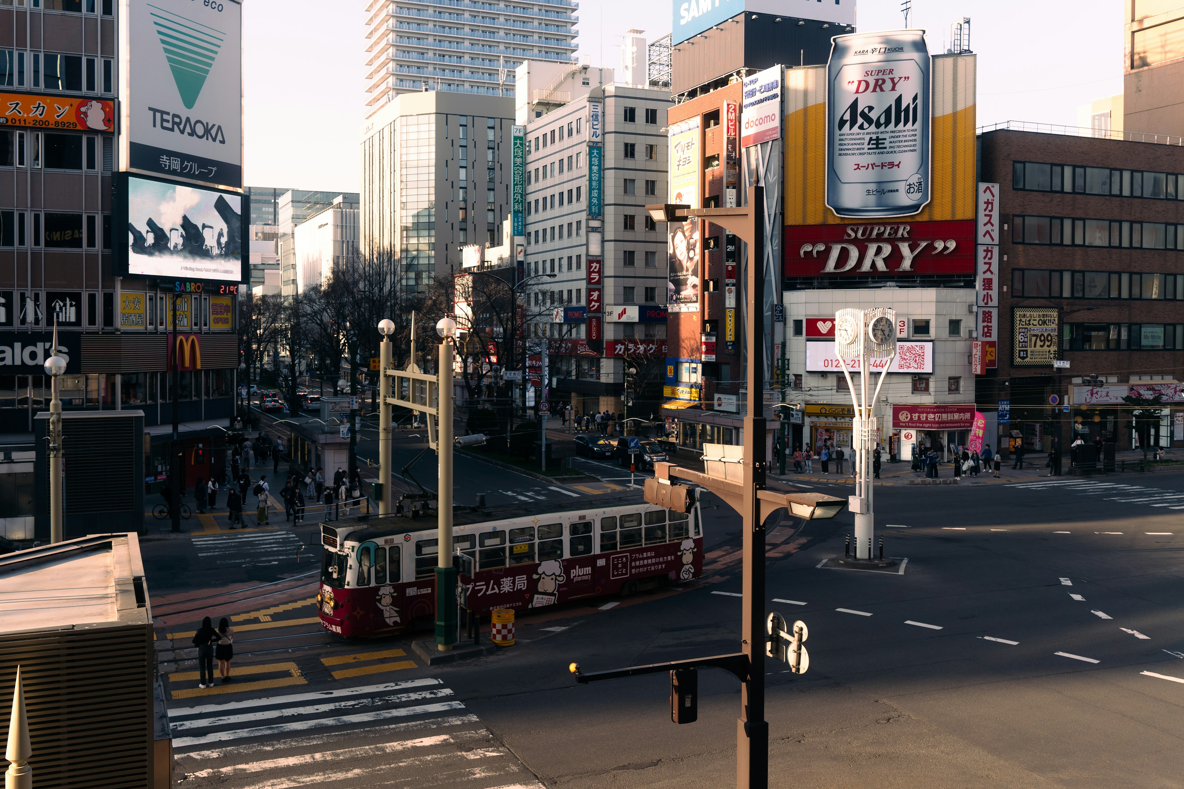 Street intersection featuring a tram and city buildings