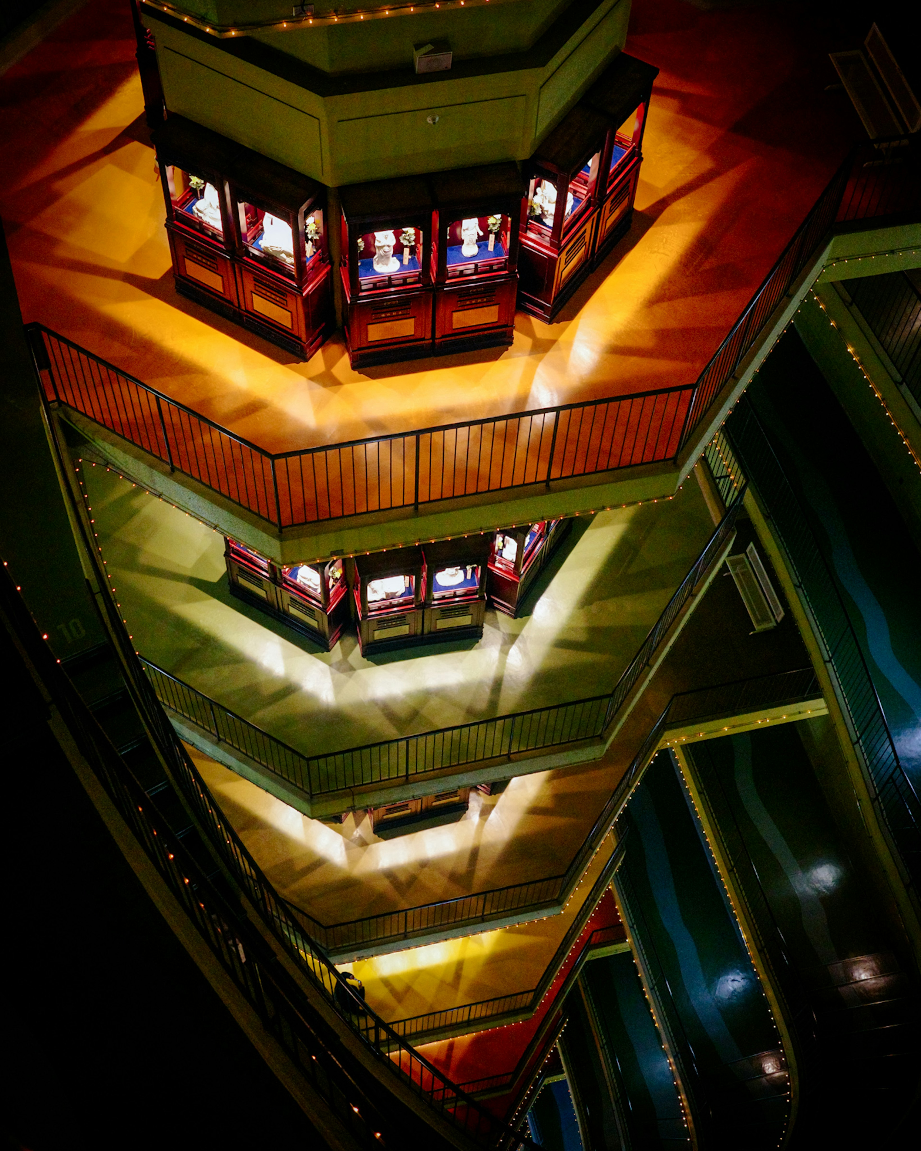 Interior view of a tiered observation deck with colorful lighting and display cases