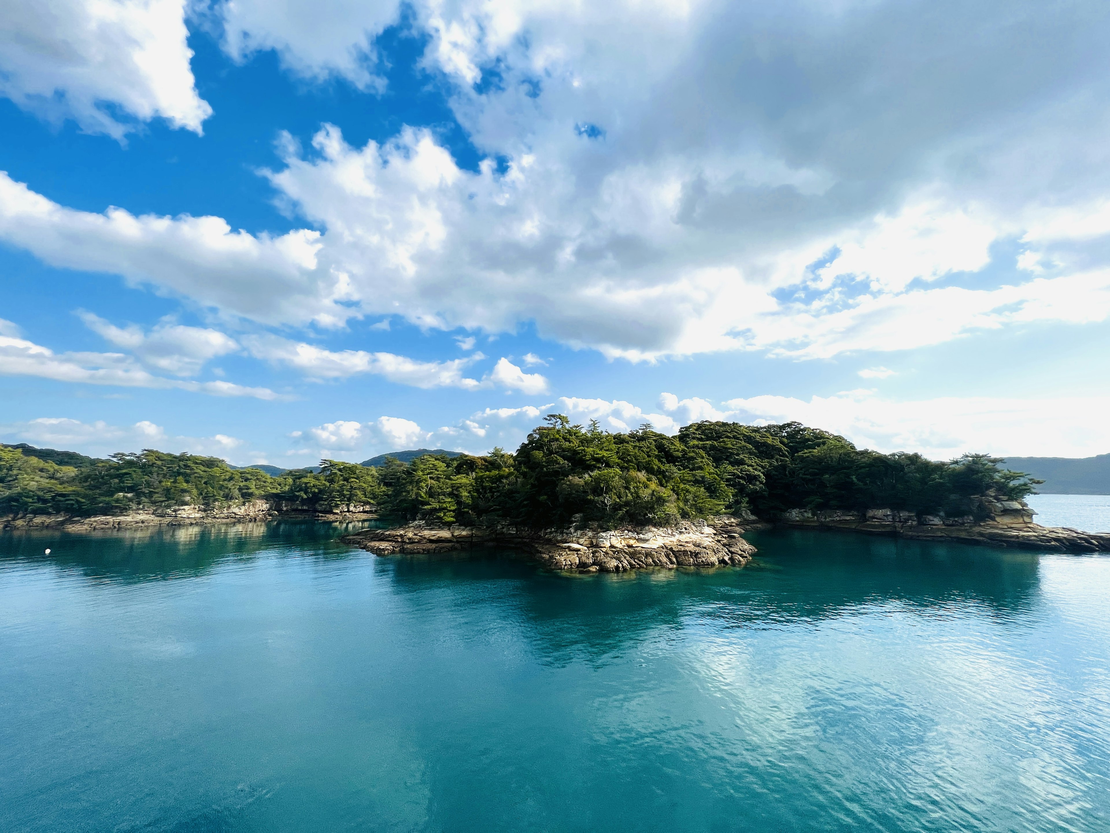 Scenic view of turquoise water and lush green islands