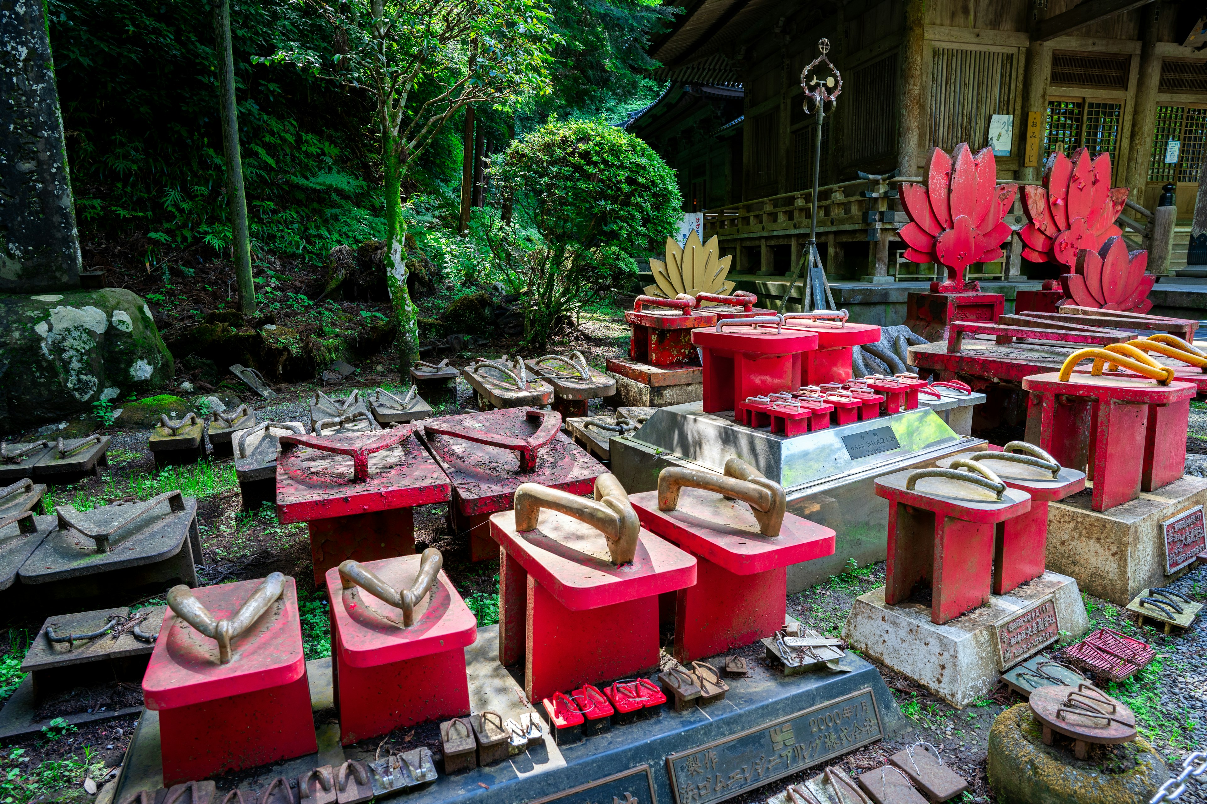 A garden scene featuring red decorative objects surrounded by green trees traditional design elements