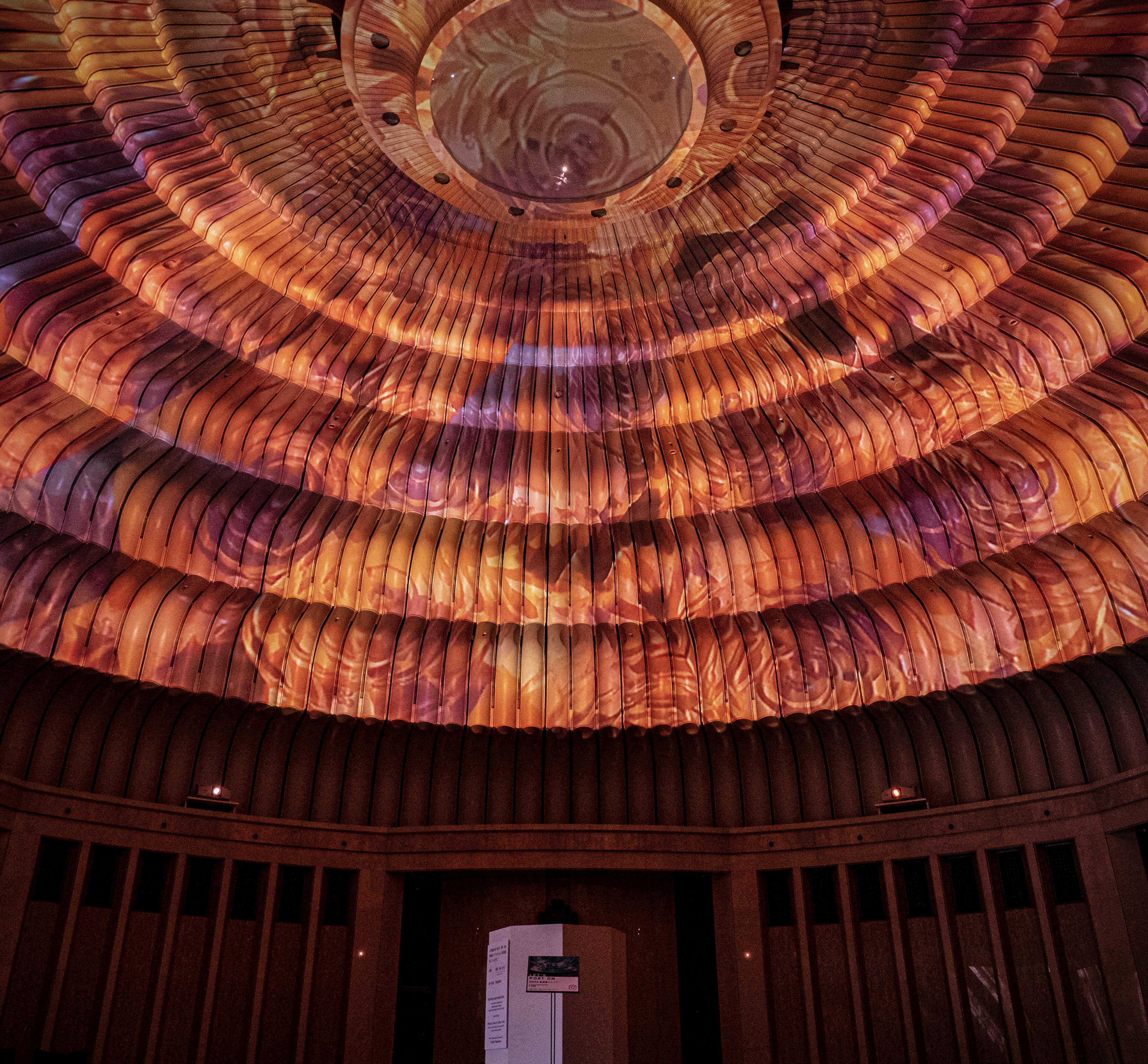 Warm colored light patterns projected on a circular ceiling