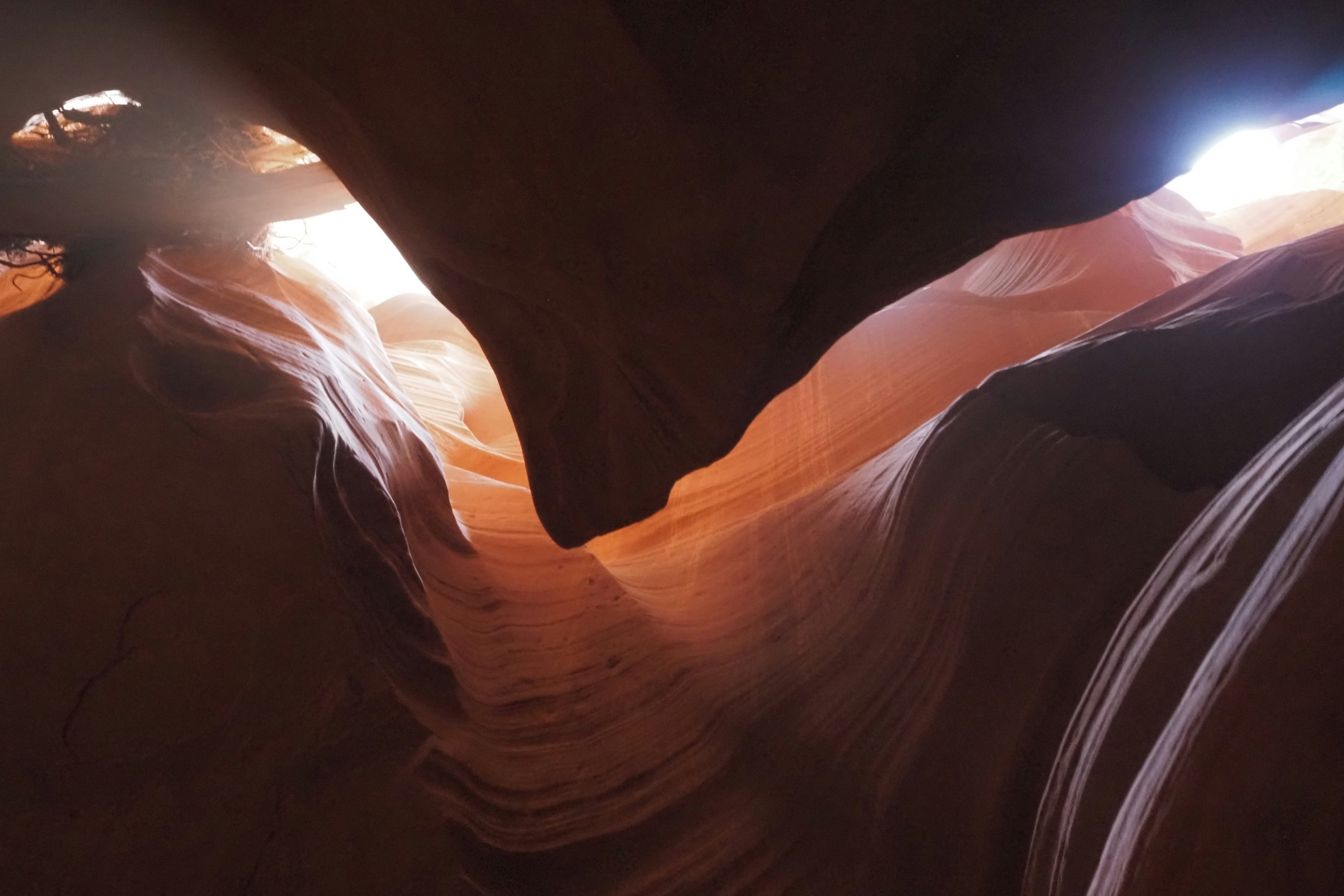 View from inside a stunning red rock canyon with light streaming in