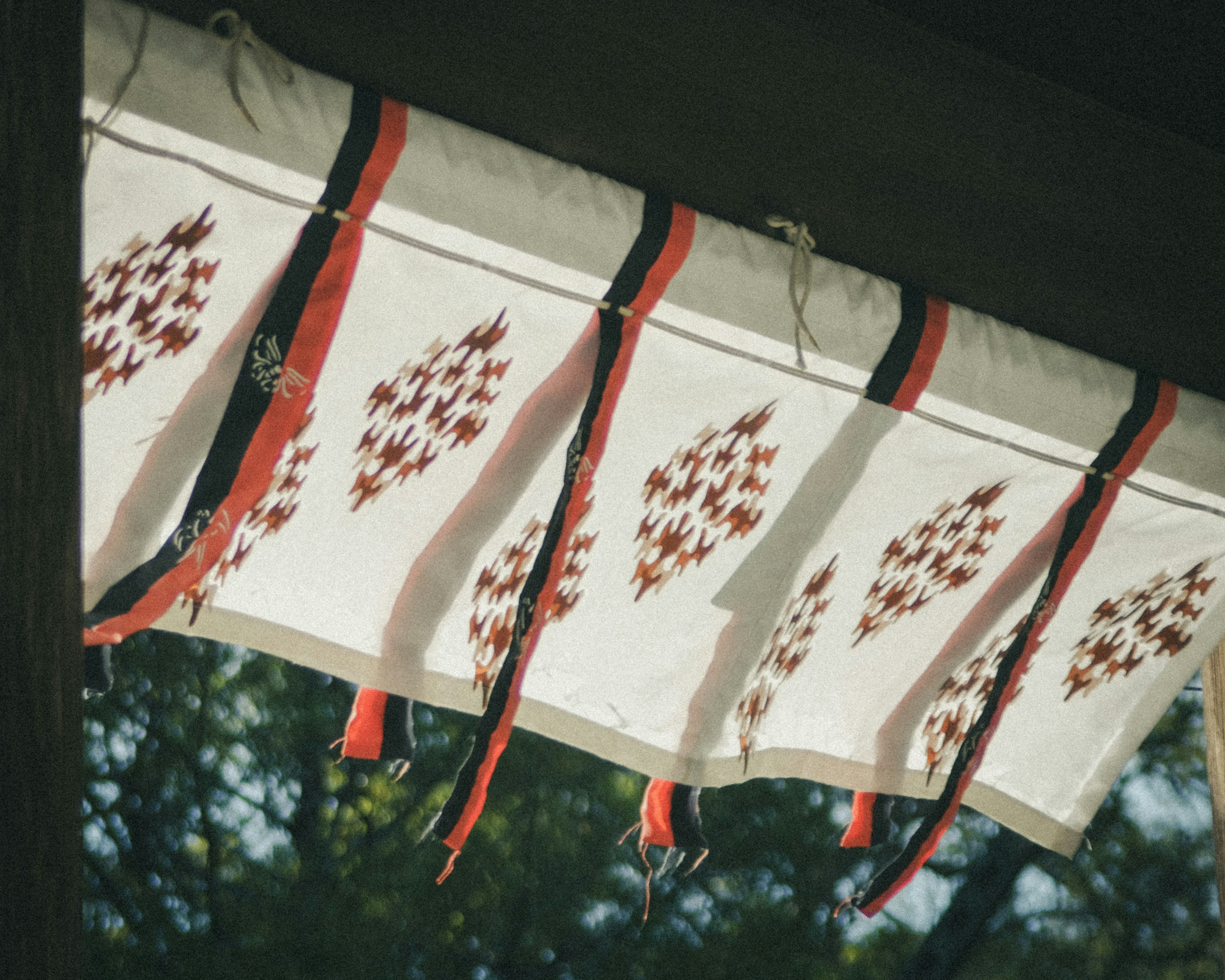 Decorative fabric with red ties and patterns on white background