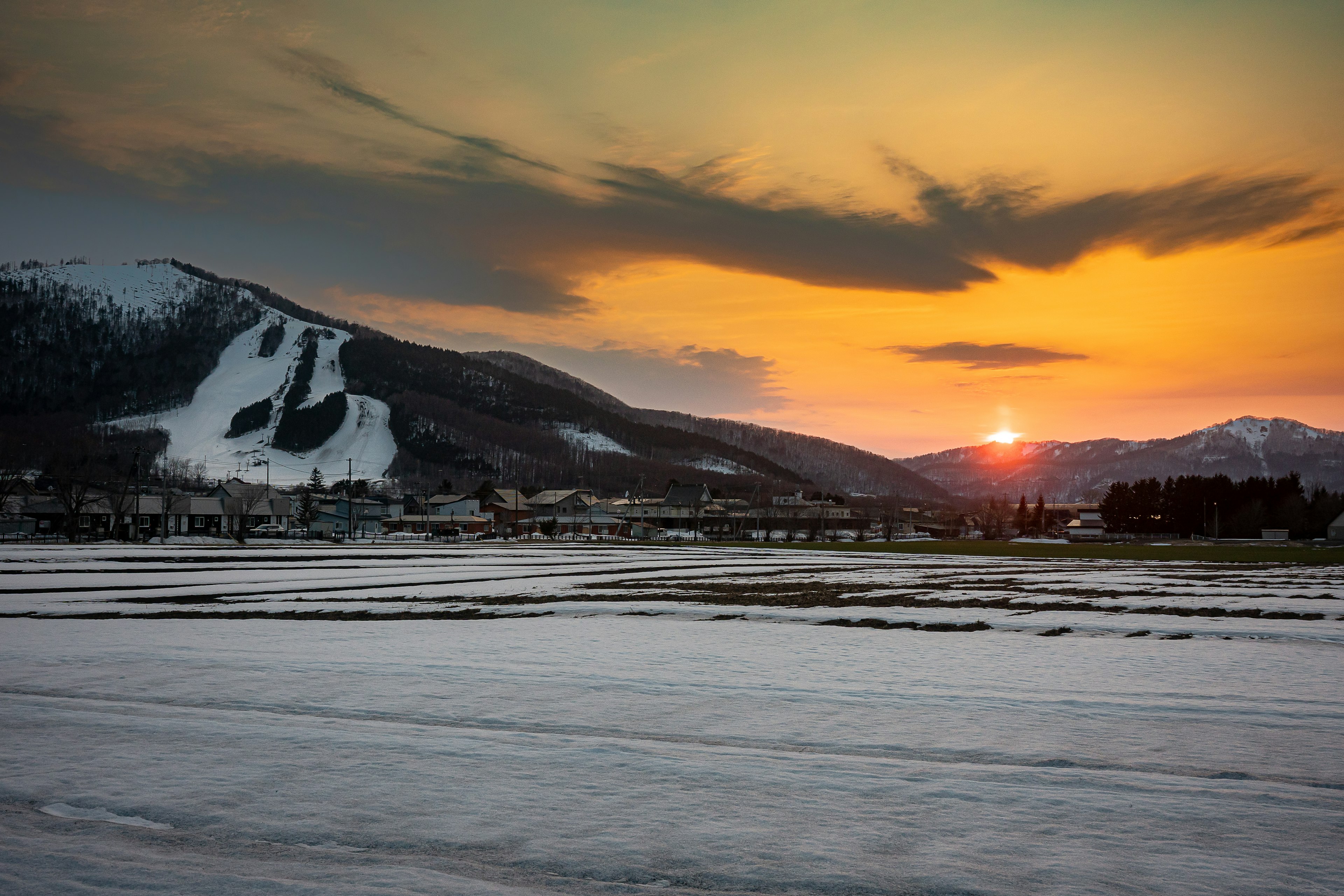 Beautiful sunset behind mountains in a snowy landscape