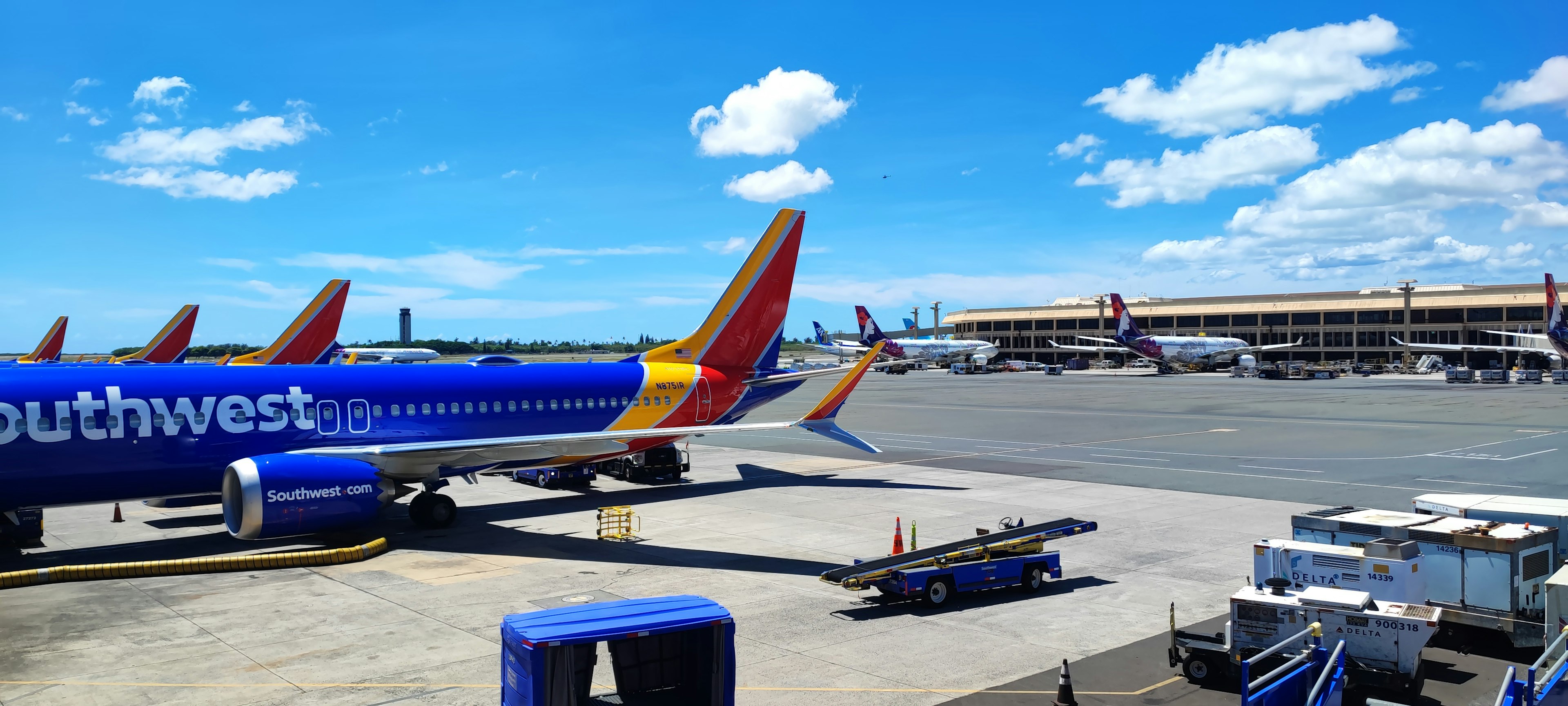 Southwest Airlines planes parked at the airport under a clear blue sky