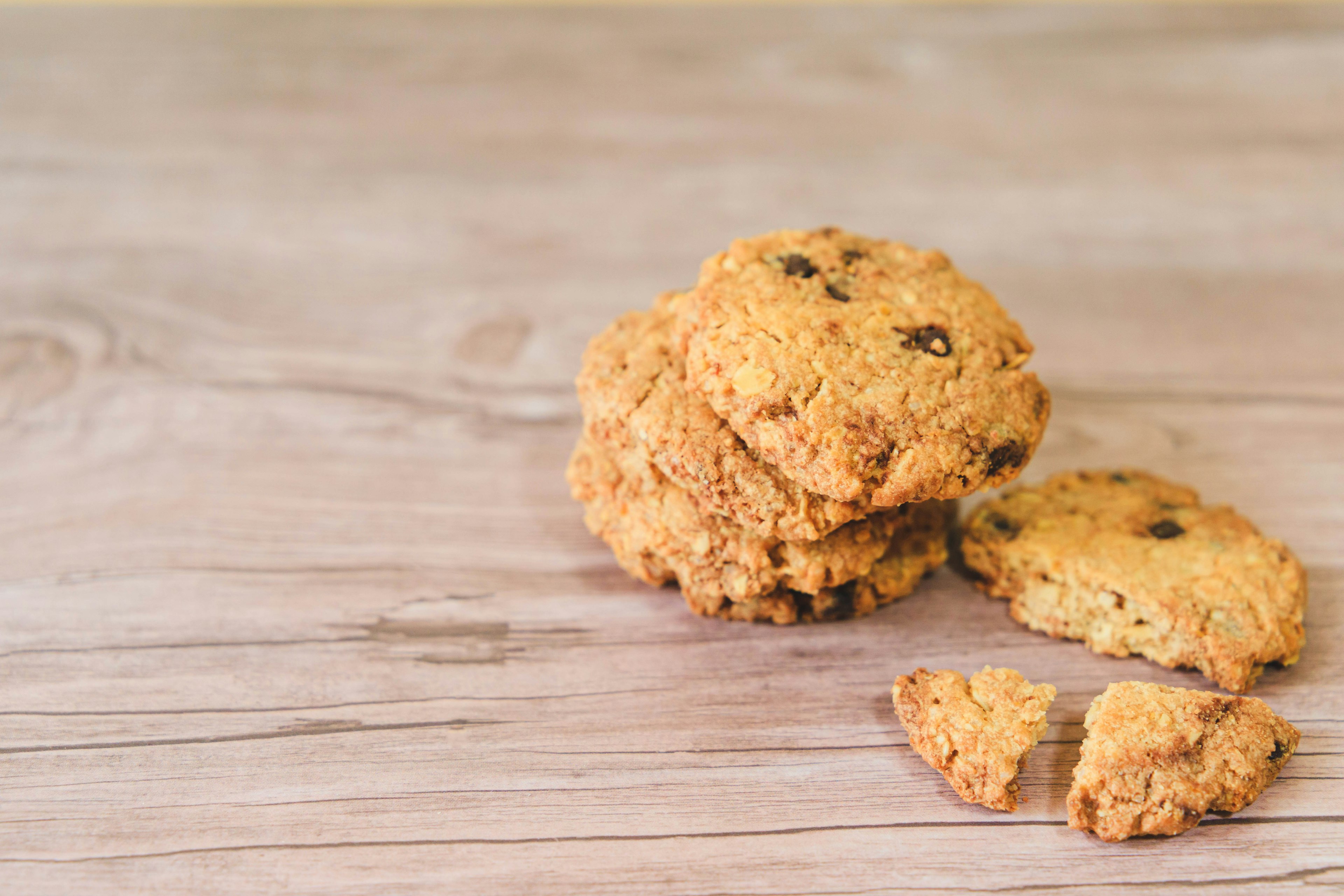 Freshly baked cookies stacked on a wooden table