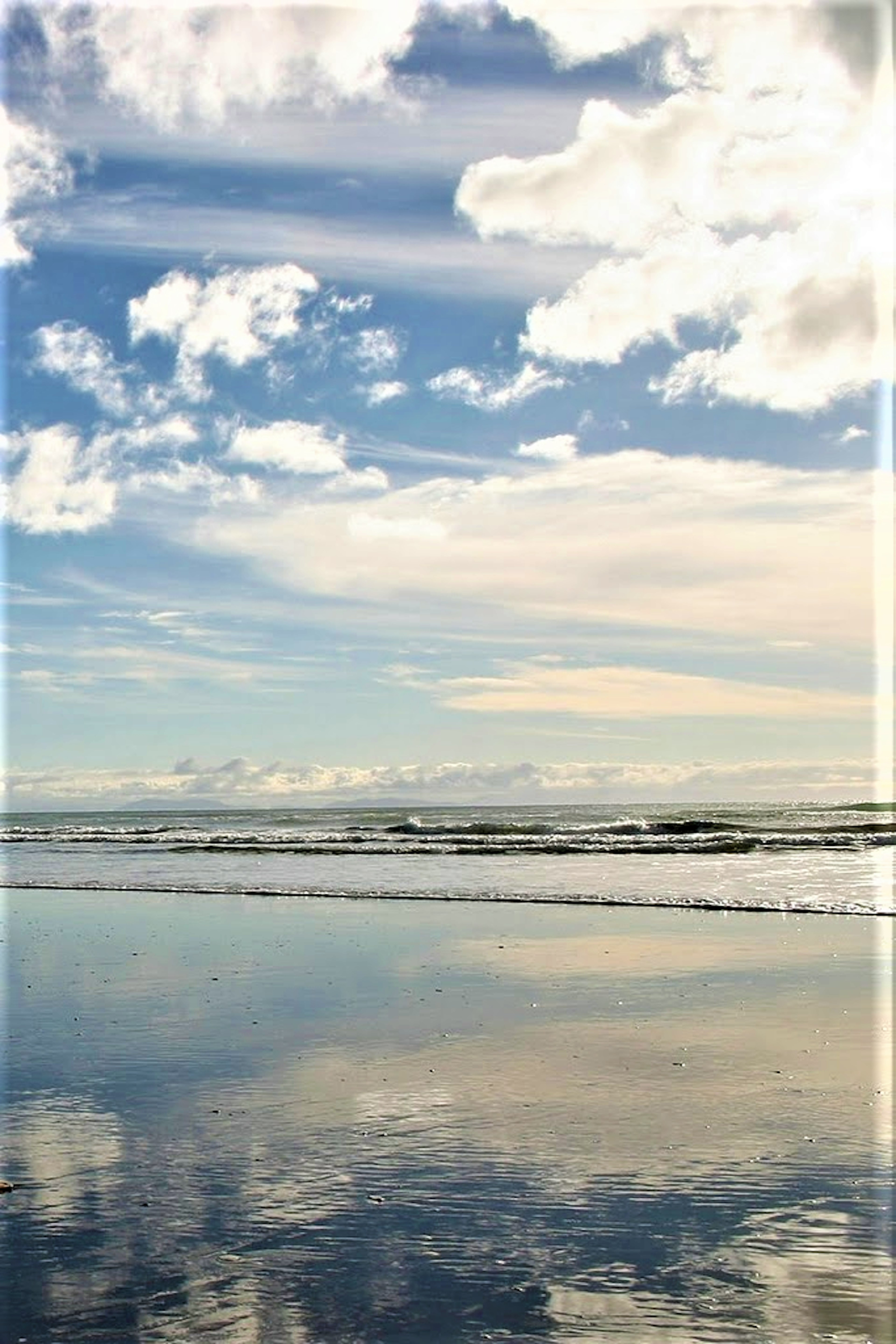 Beautiful landscape of ocean and sky with clouds reflected in the water