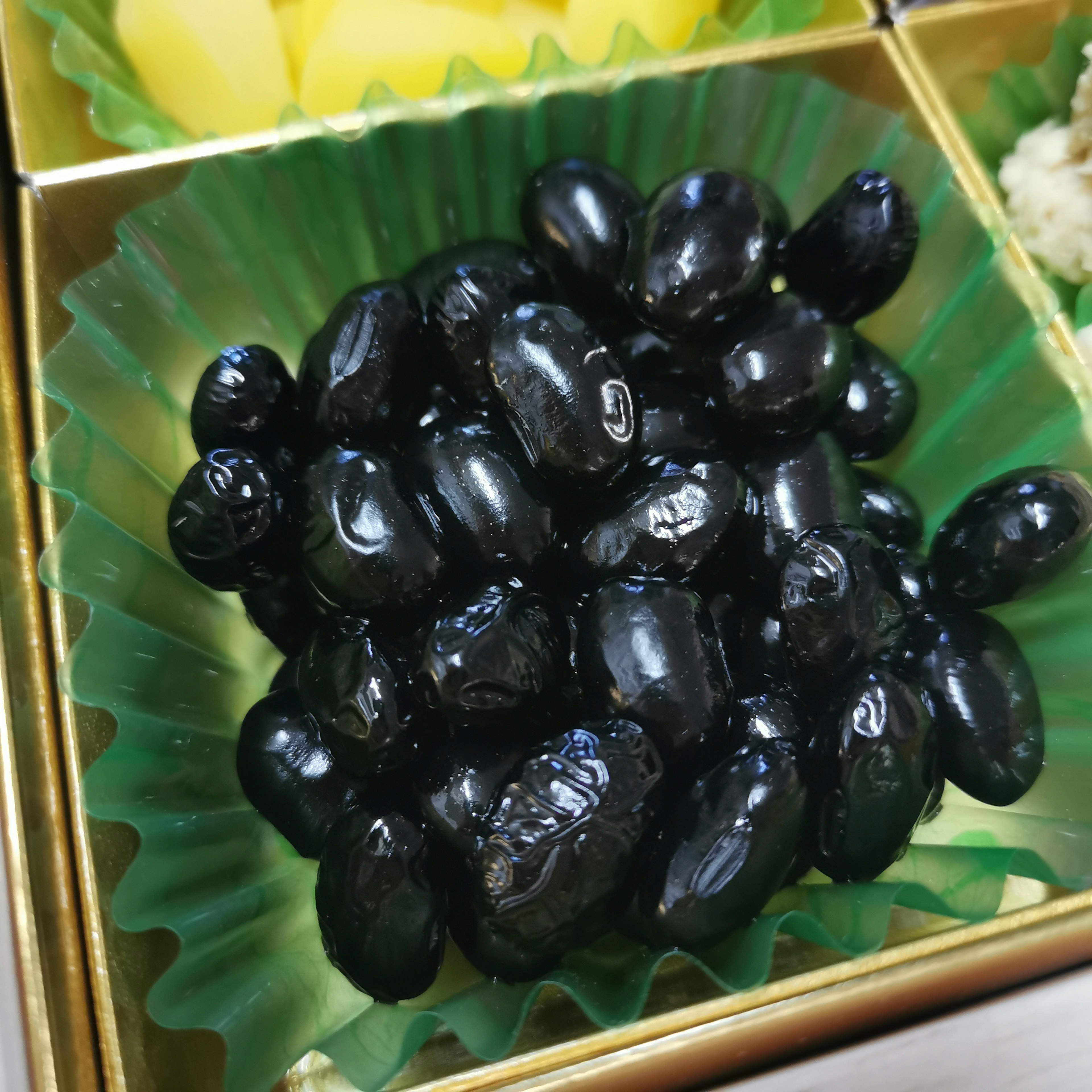 Black beans arranged in a green cup