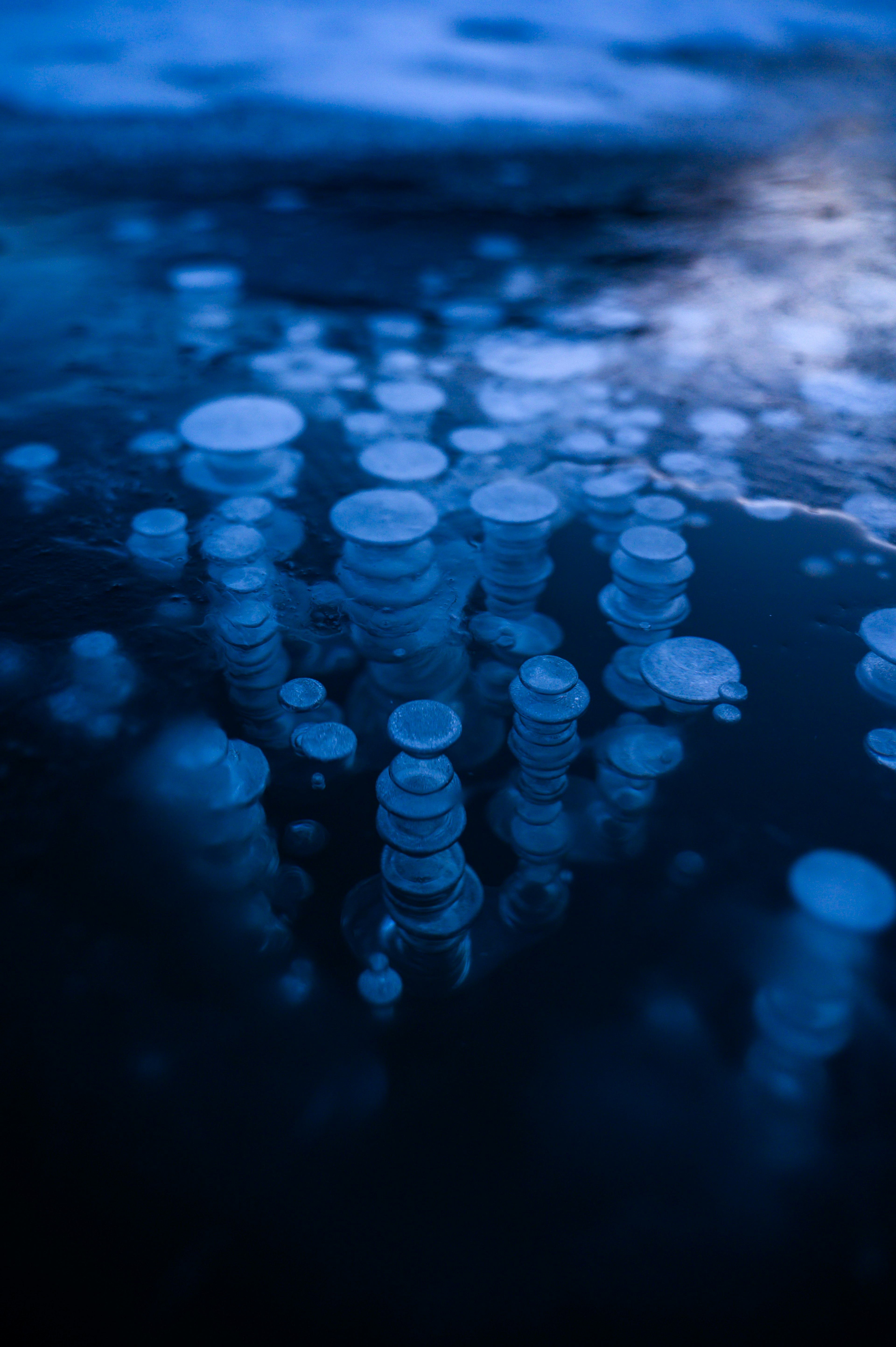 Bubbles resembling ice floating on a blue surface