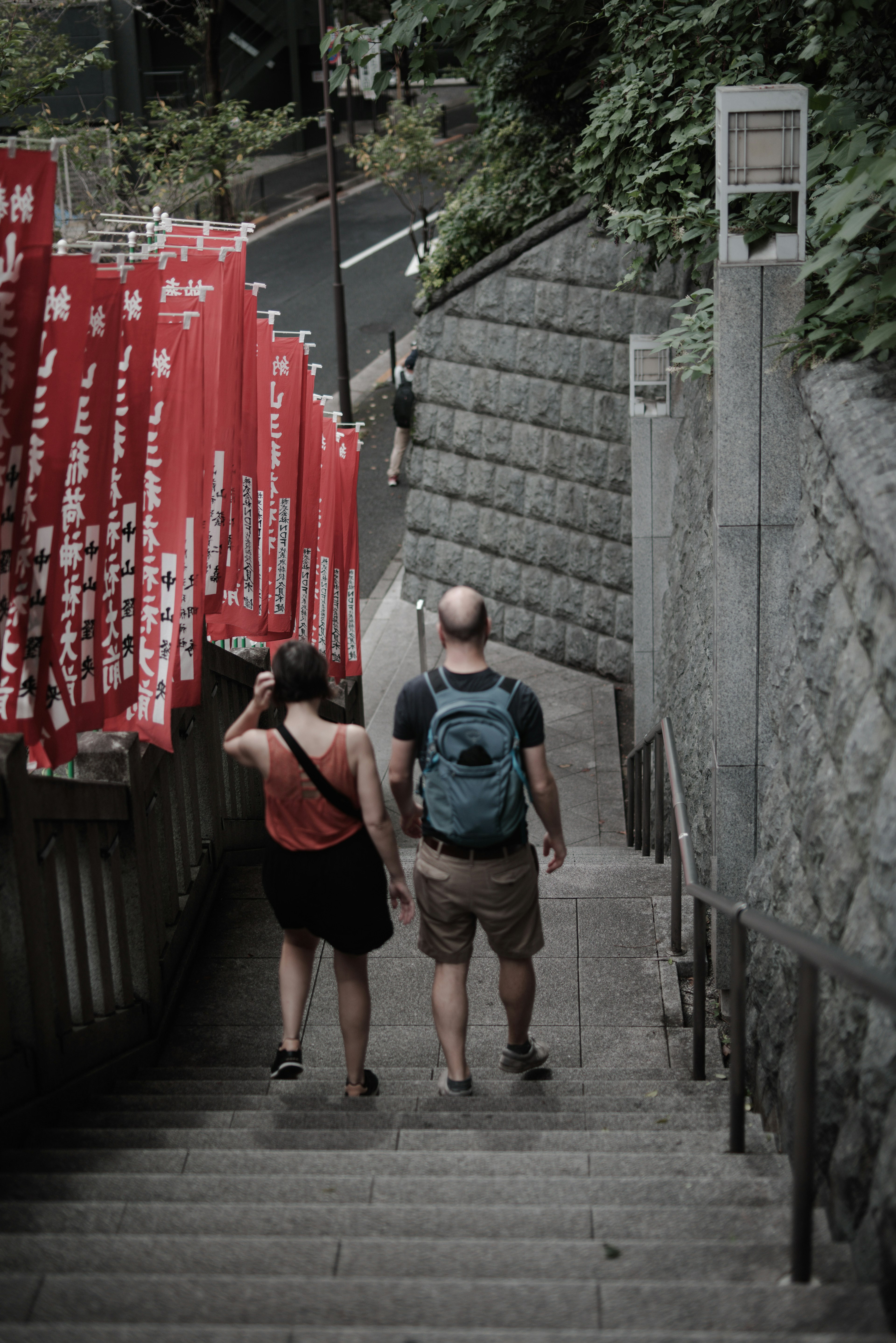 Couple walking down stairs with red banners on the side