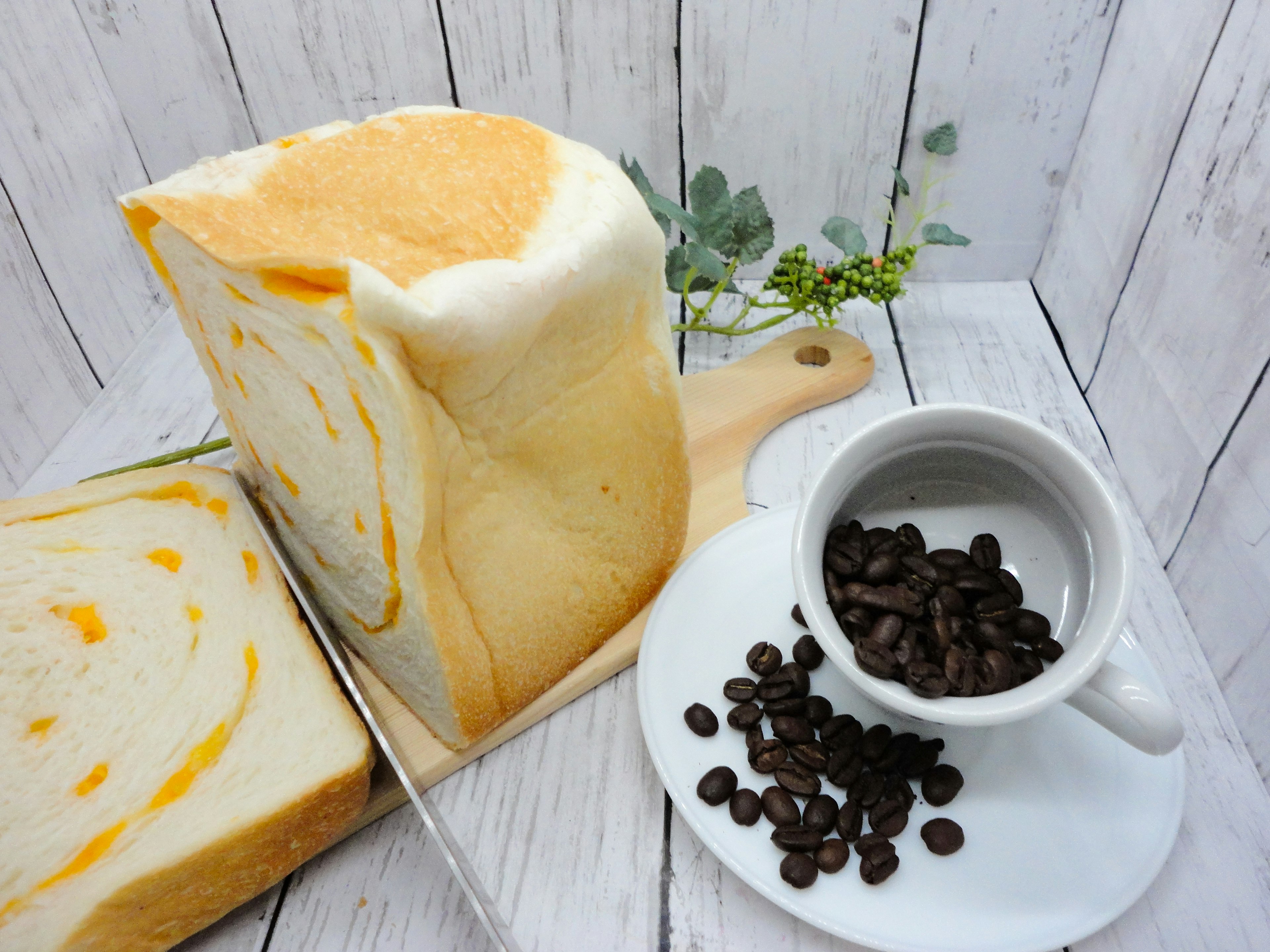 Orange marble bread with a cup of coffee beans on a wooden table