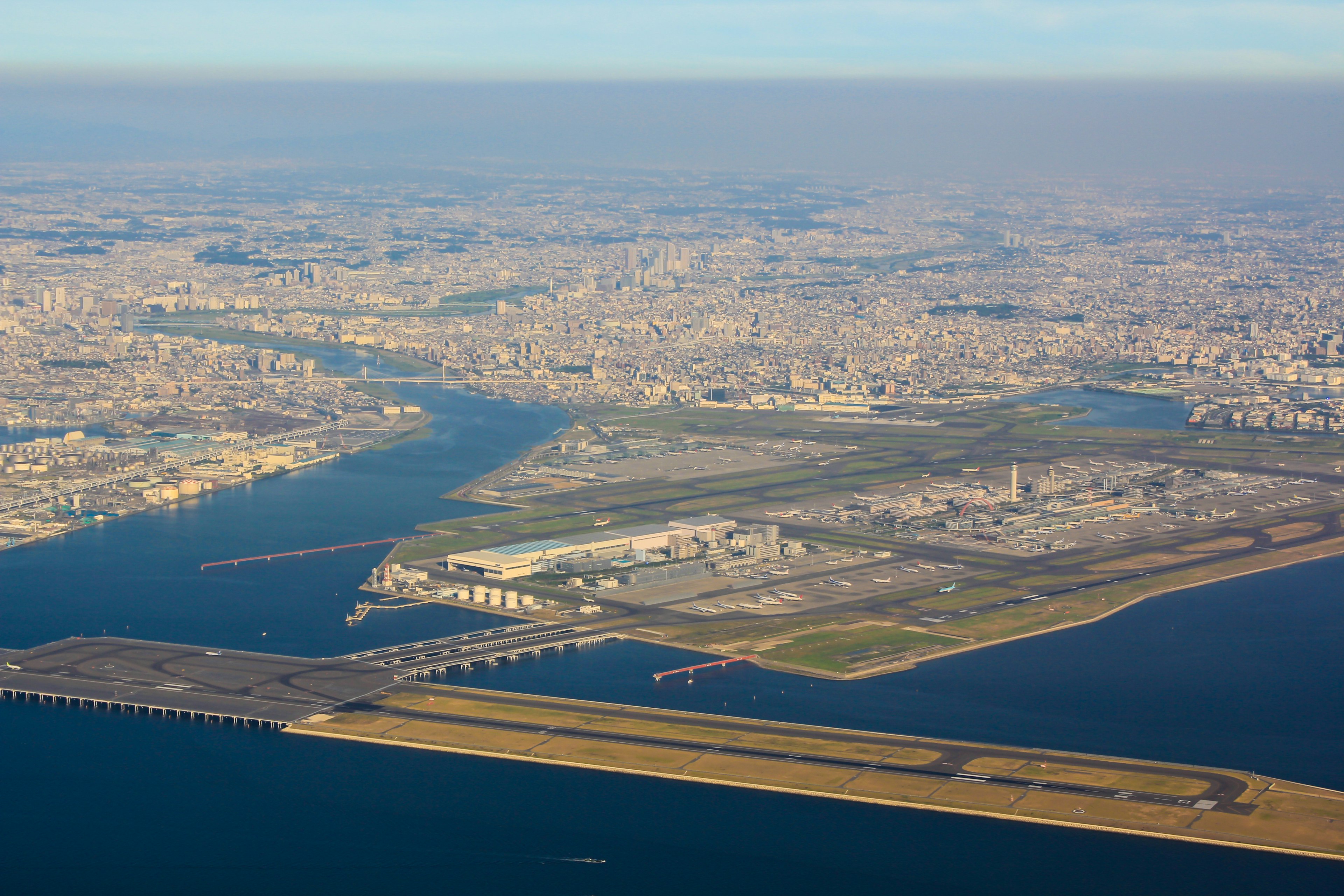 Aerial view of a city with waterways and industrial areas visible