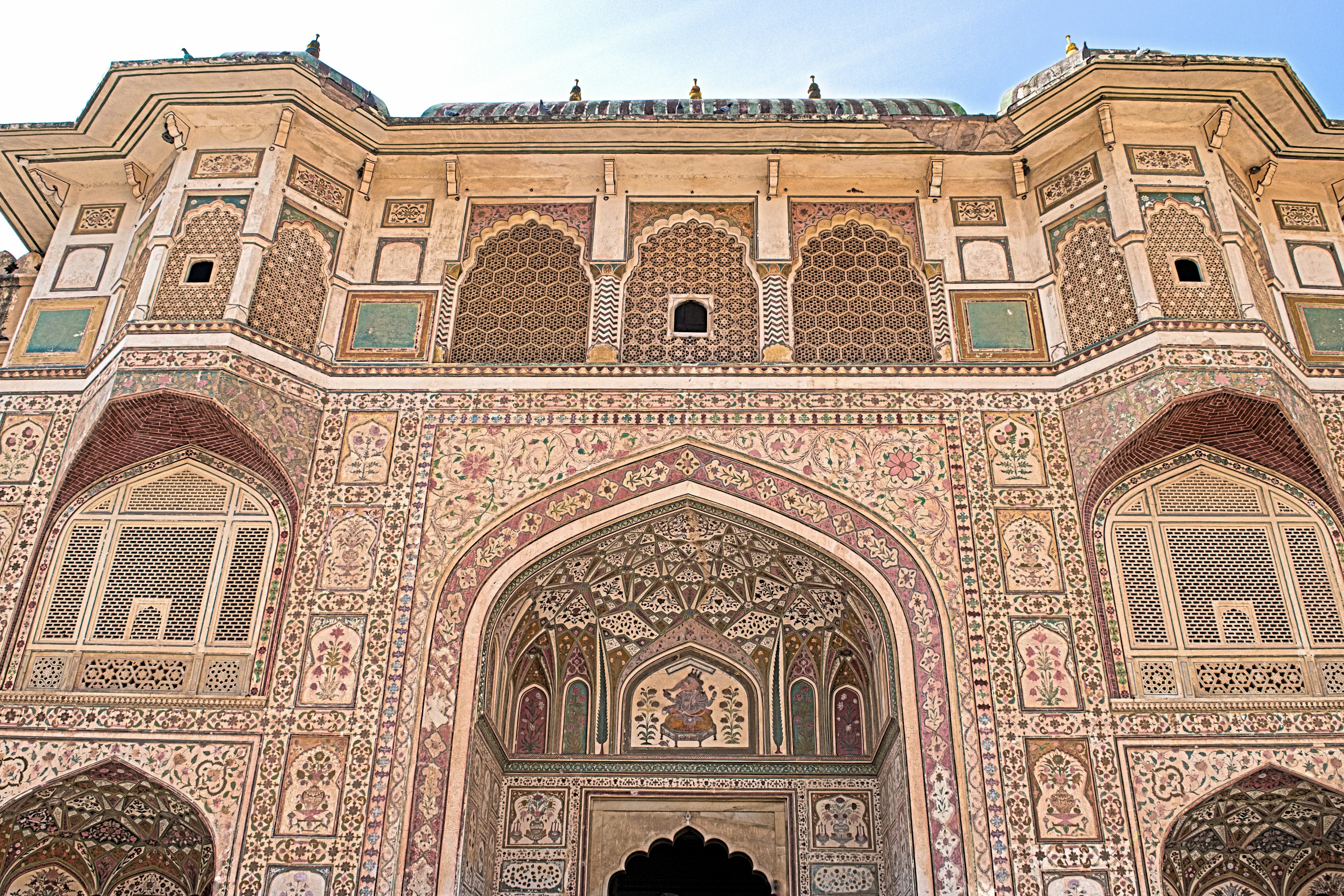 Intricate entrance of Amber Fort showcasing detailed carvings and vibrant colors