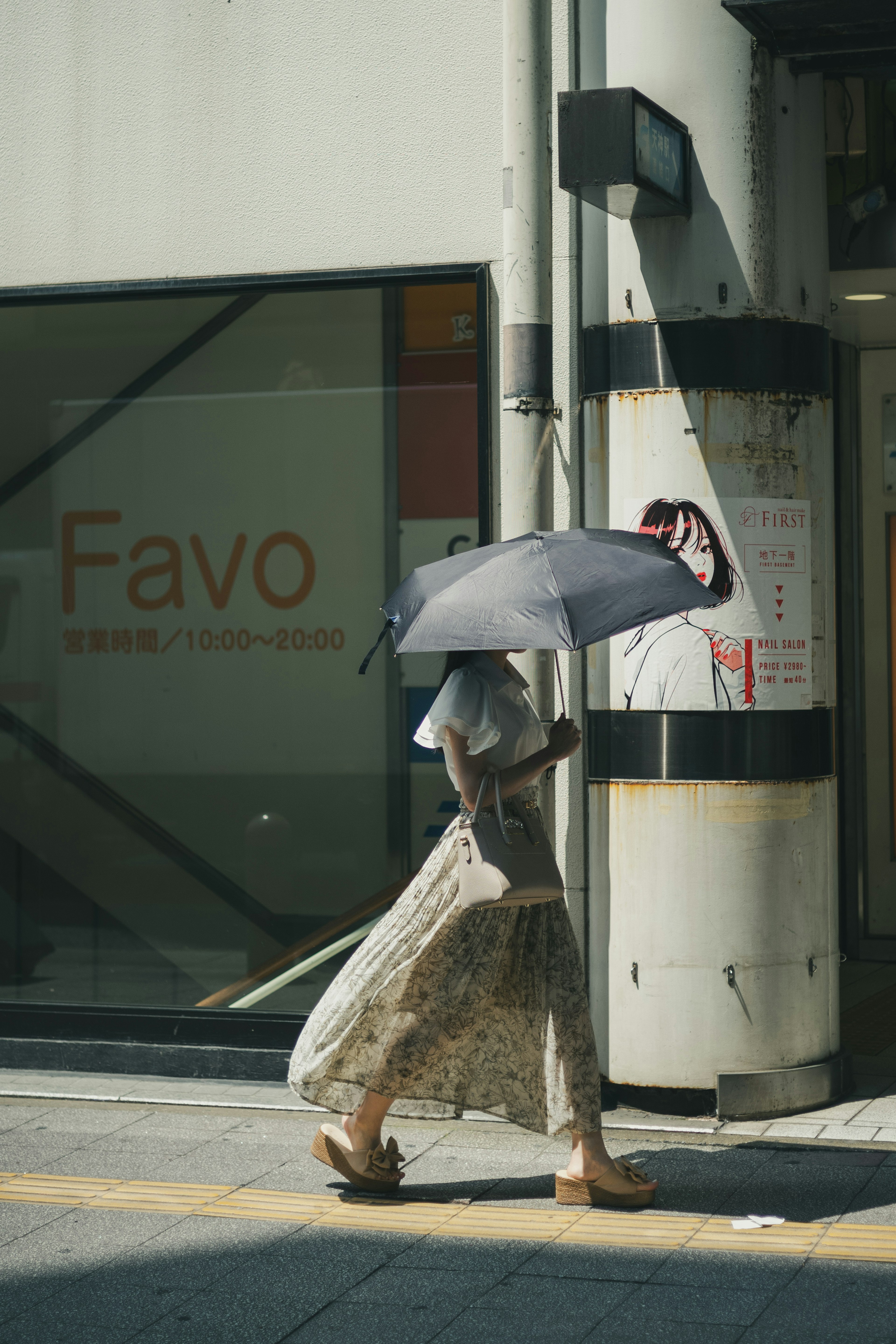 A woman walking with an umbrella in a city scene