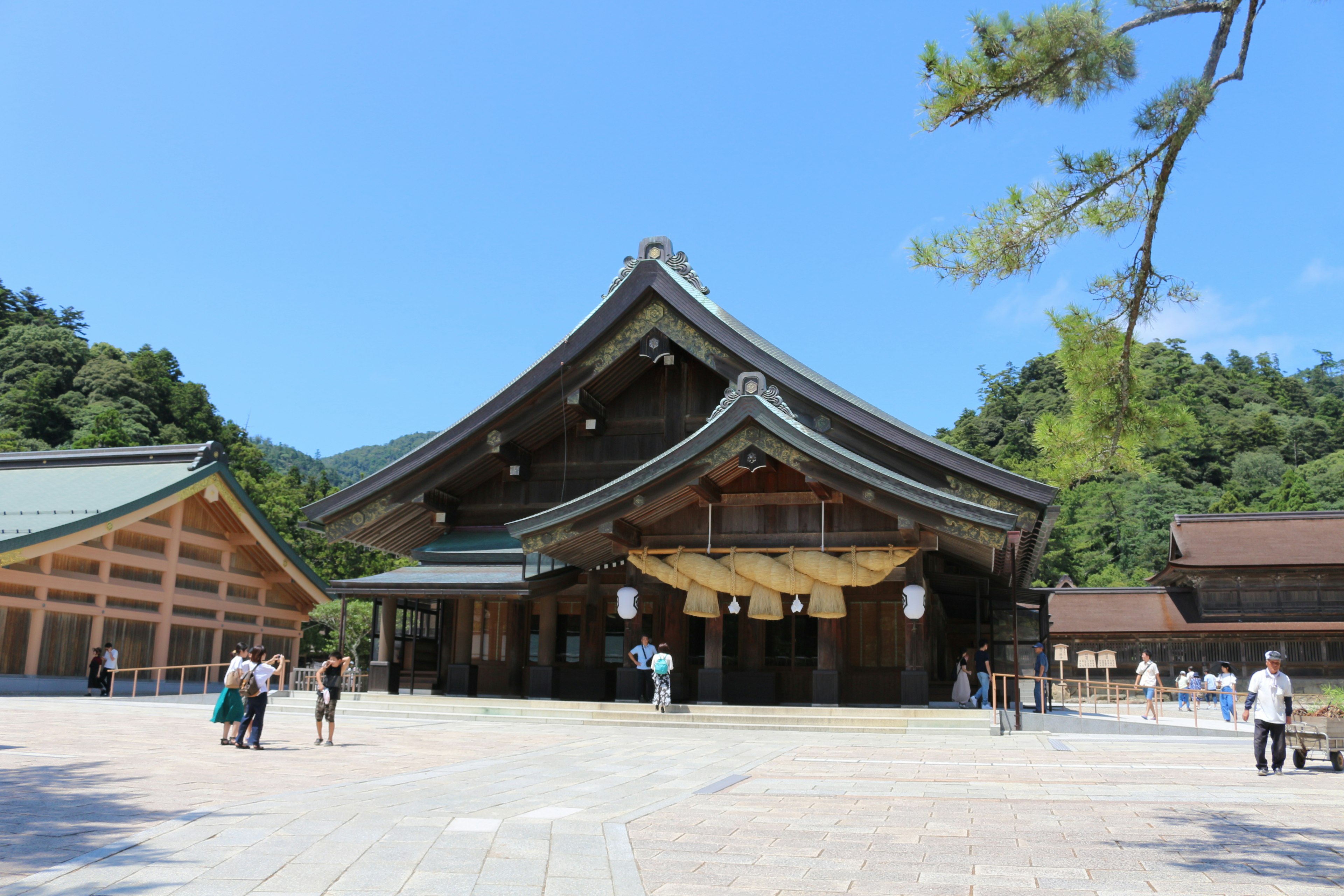 Traditional Japanese shrine with wooden architecture and clear blue sky