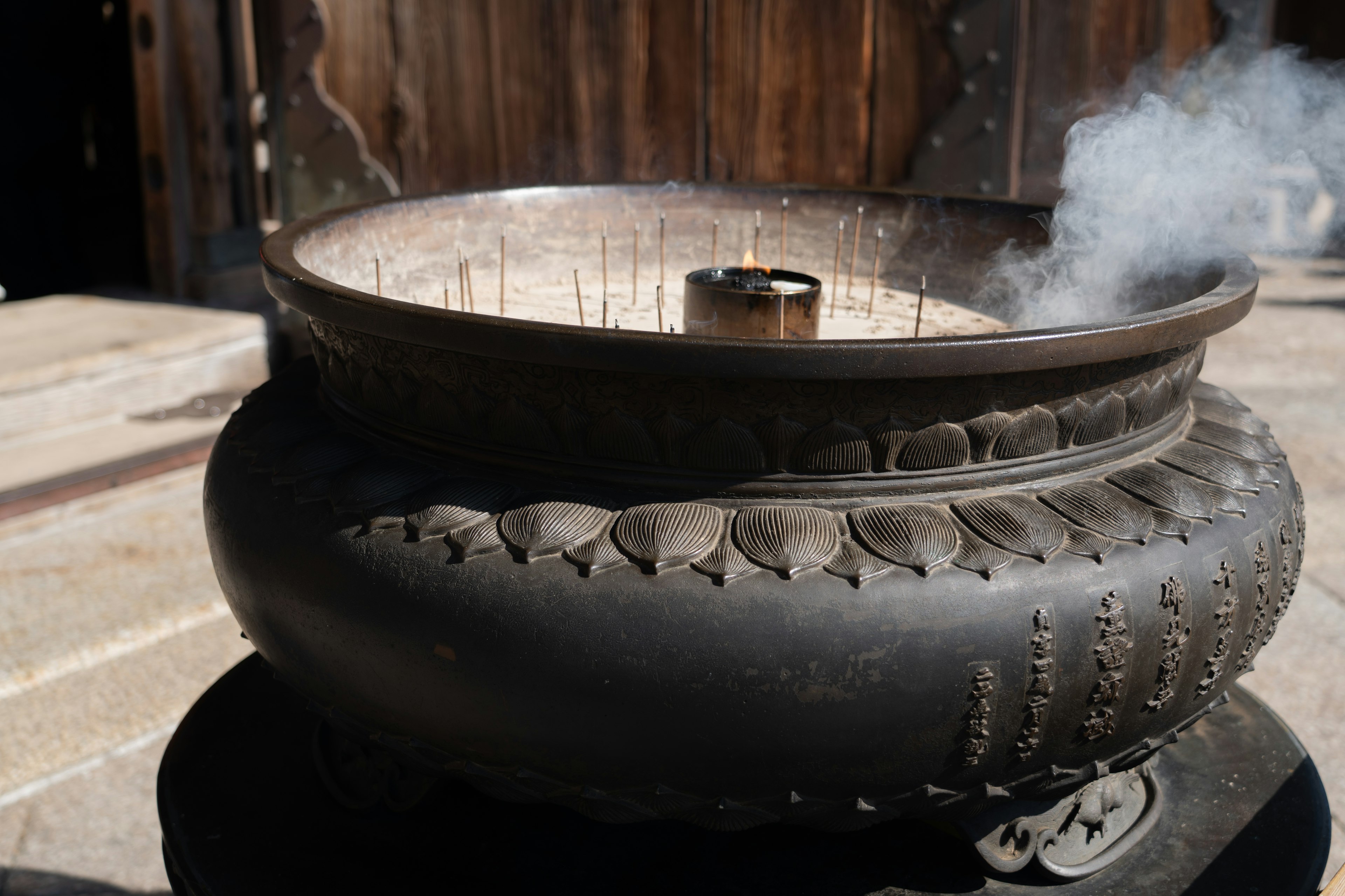 Black incense burner with smoke rising