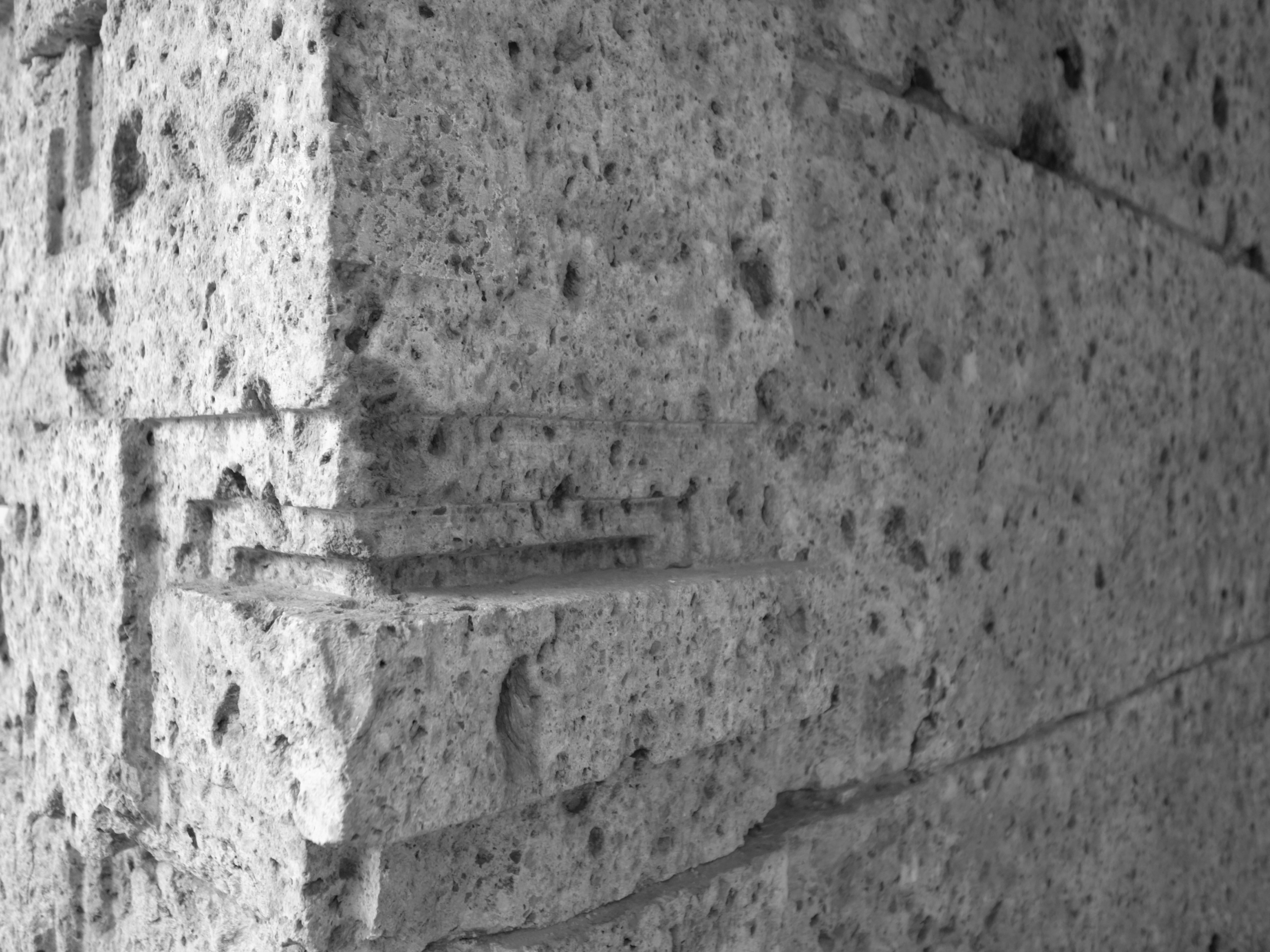 Close-up view of textured gray concrete blocks stacked