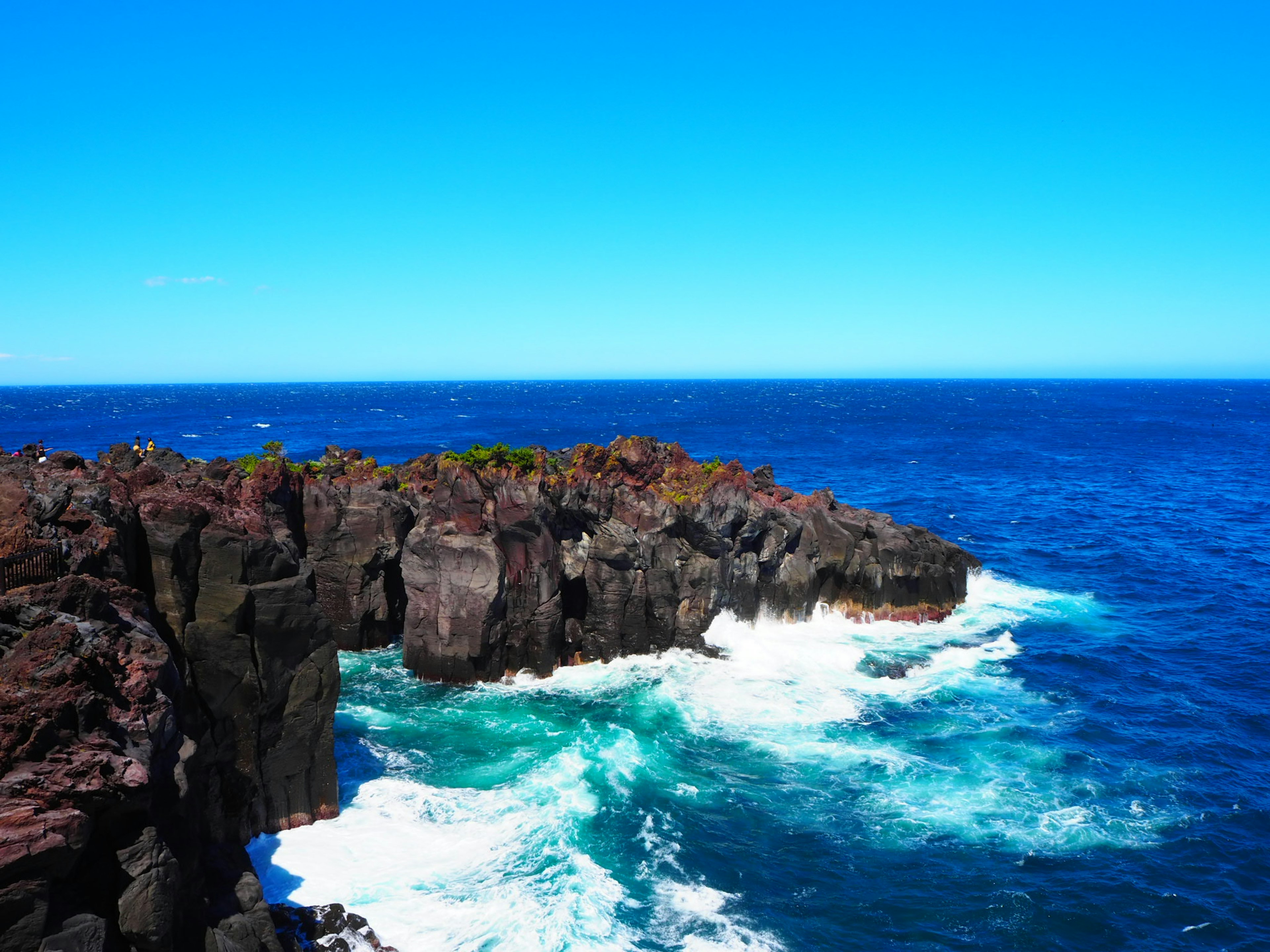 Scenic view of blue ocean and rocky cliff