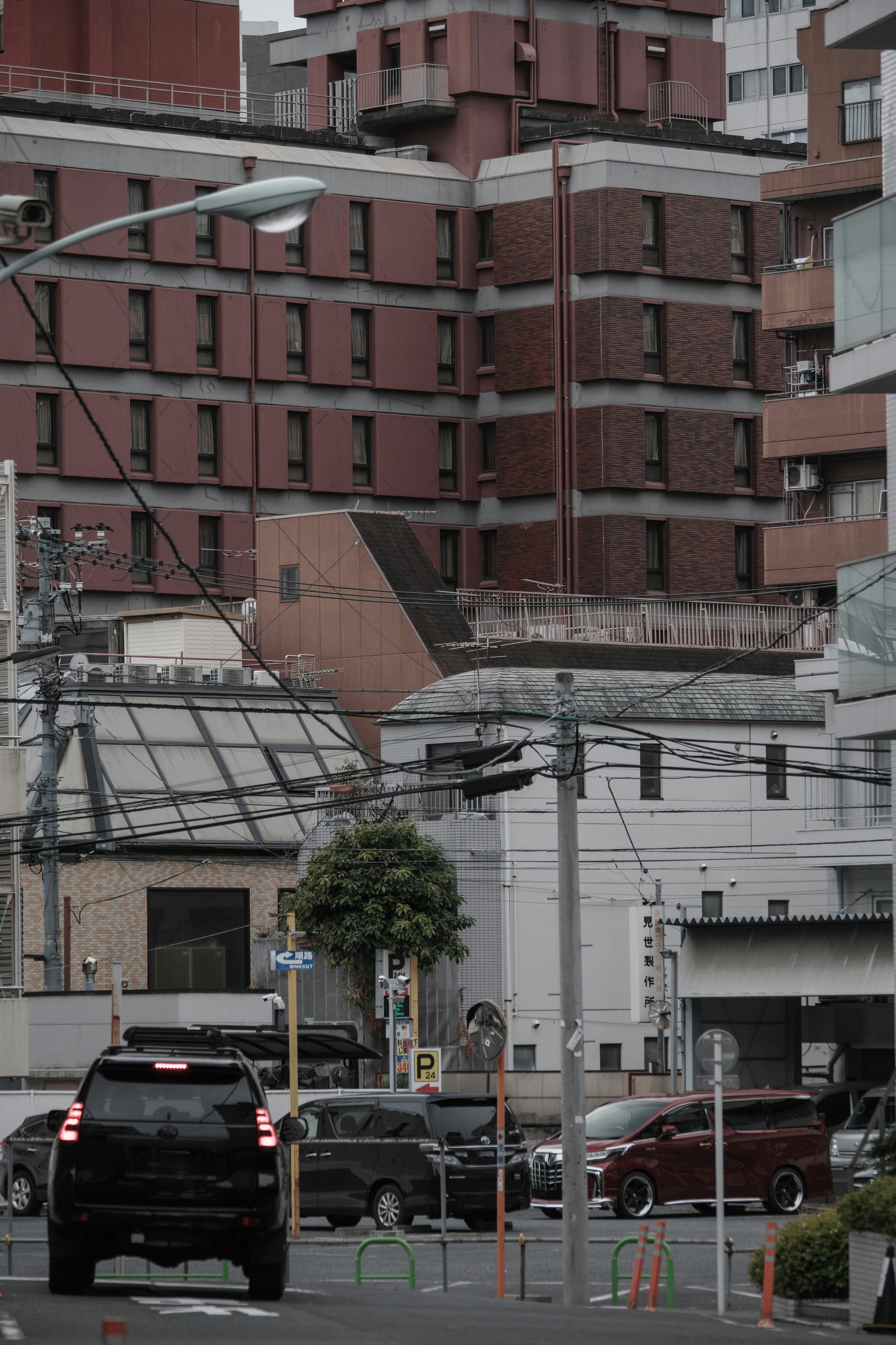 赤い建物と黒い車がある都市の風景