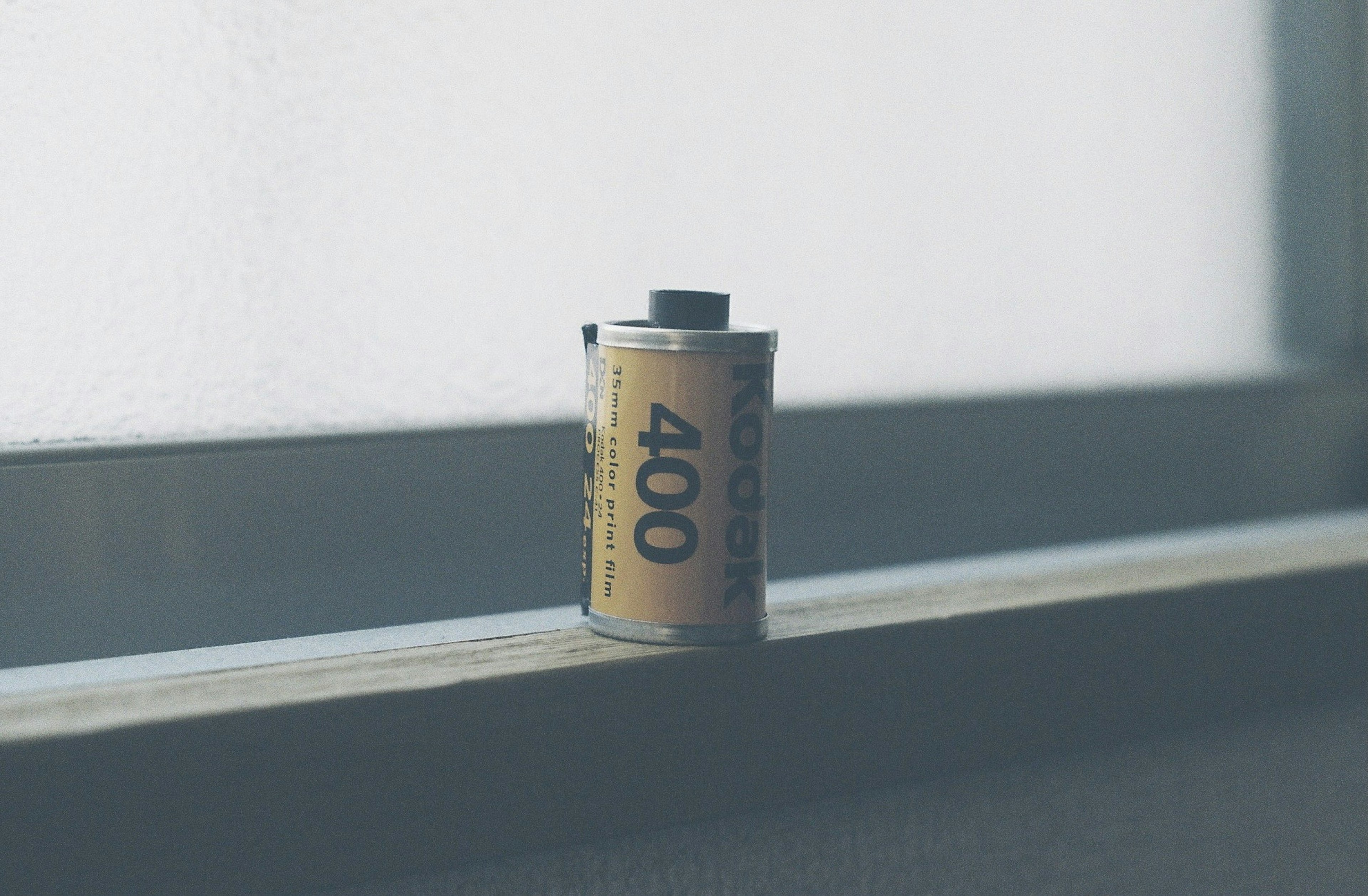 A roll of 400 film placed on a windowsill