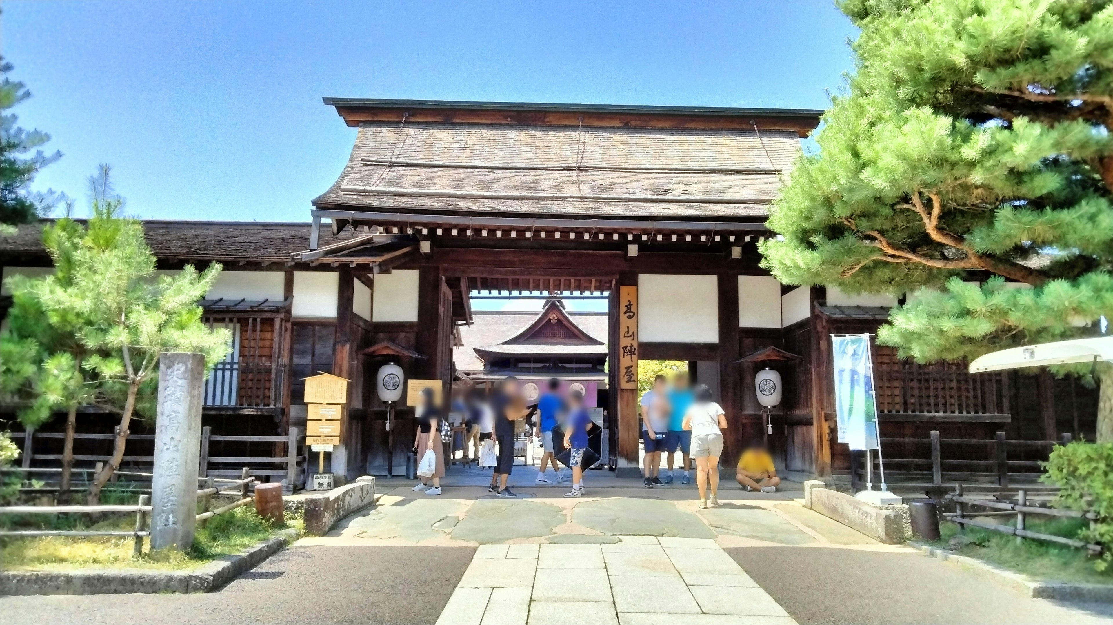 Tourists gather in front of a traditional Japanese gate