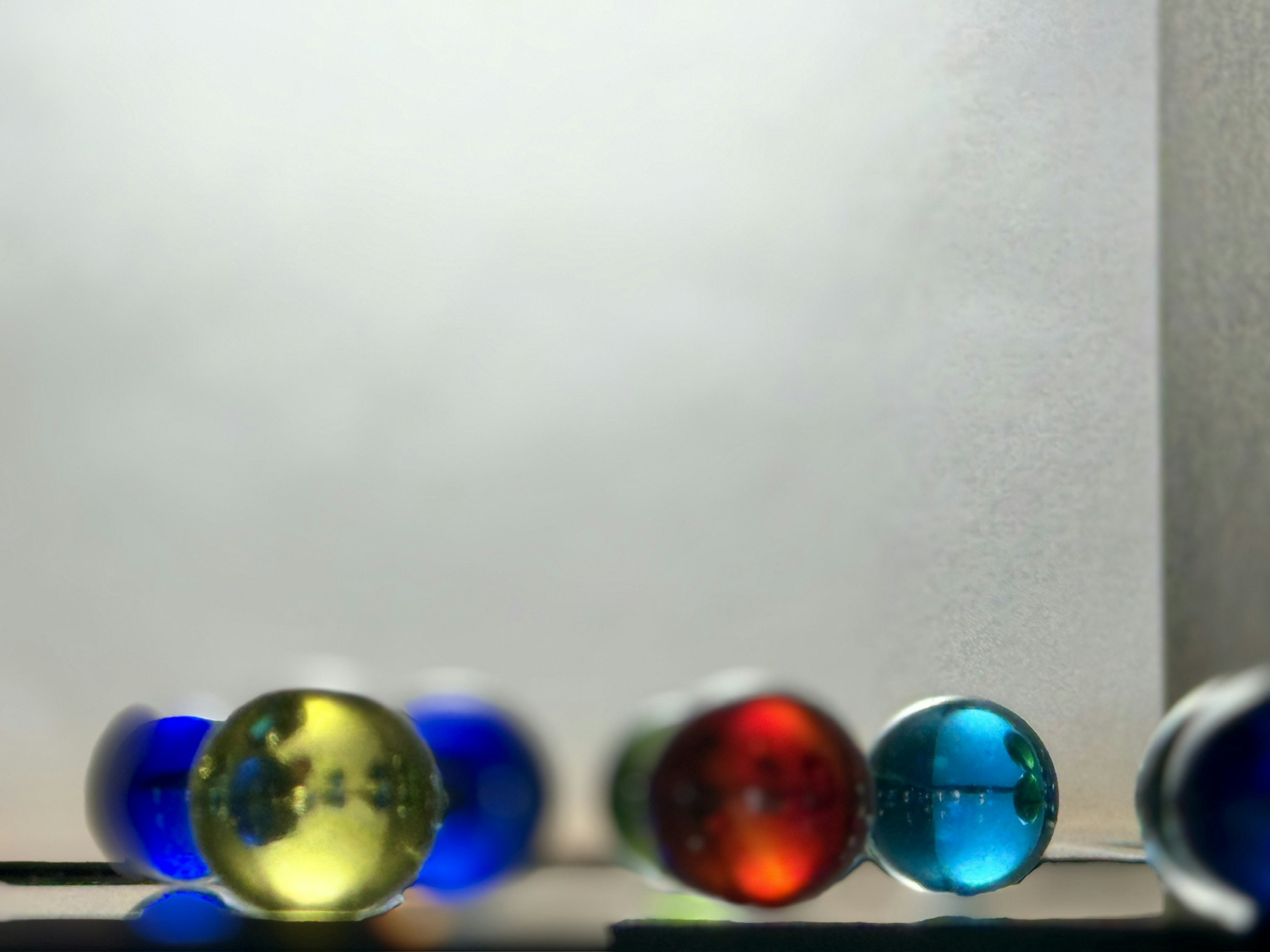 Colorful glass marbles arranged in a blurred image