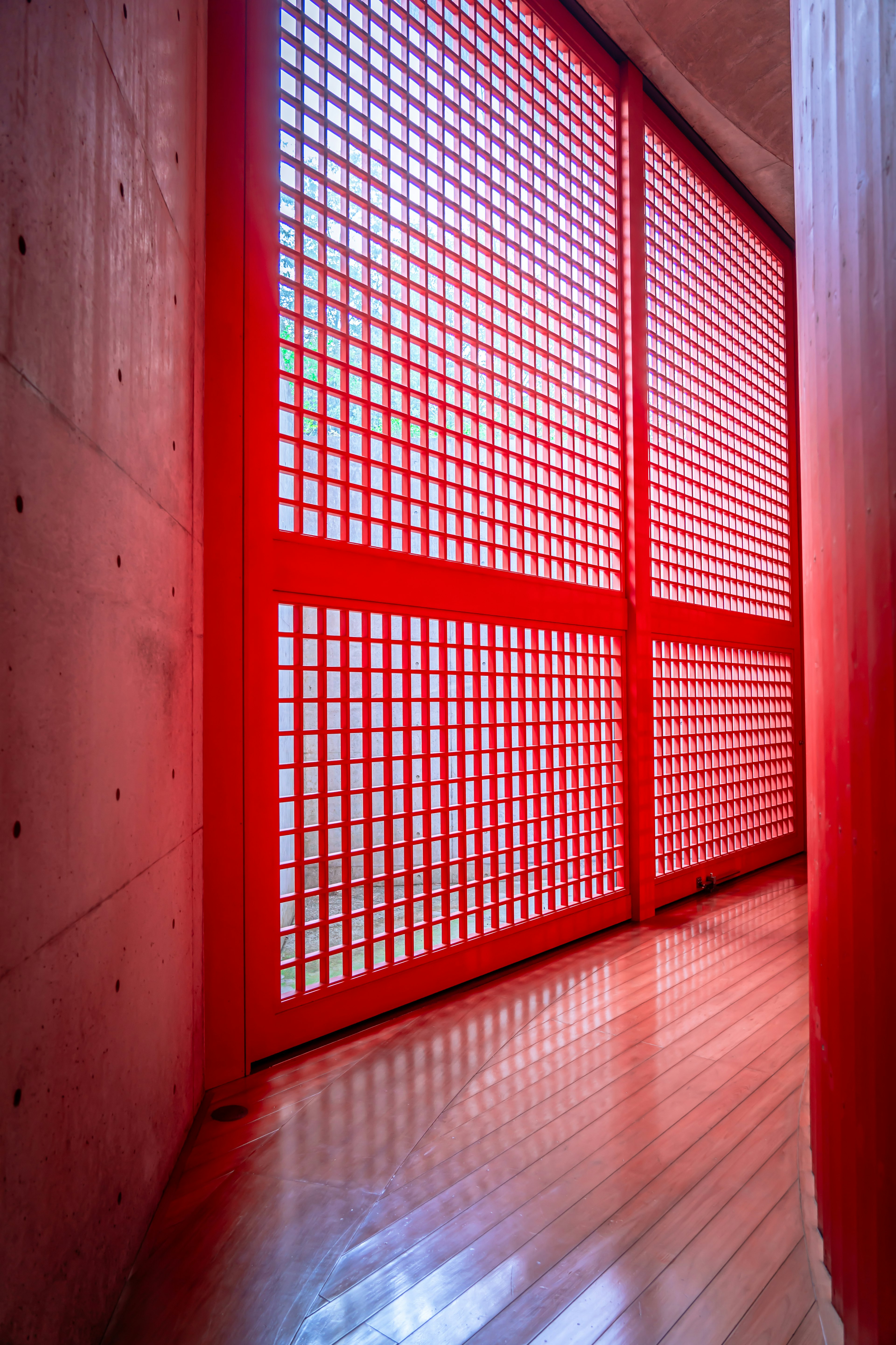 Modern interior space featuring a striking red grid window