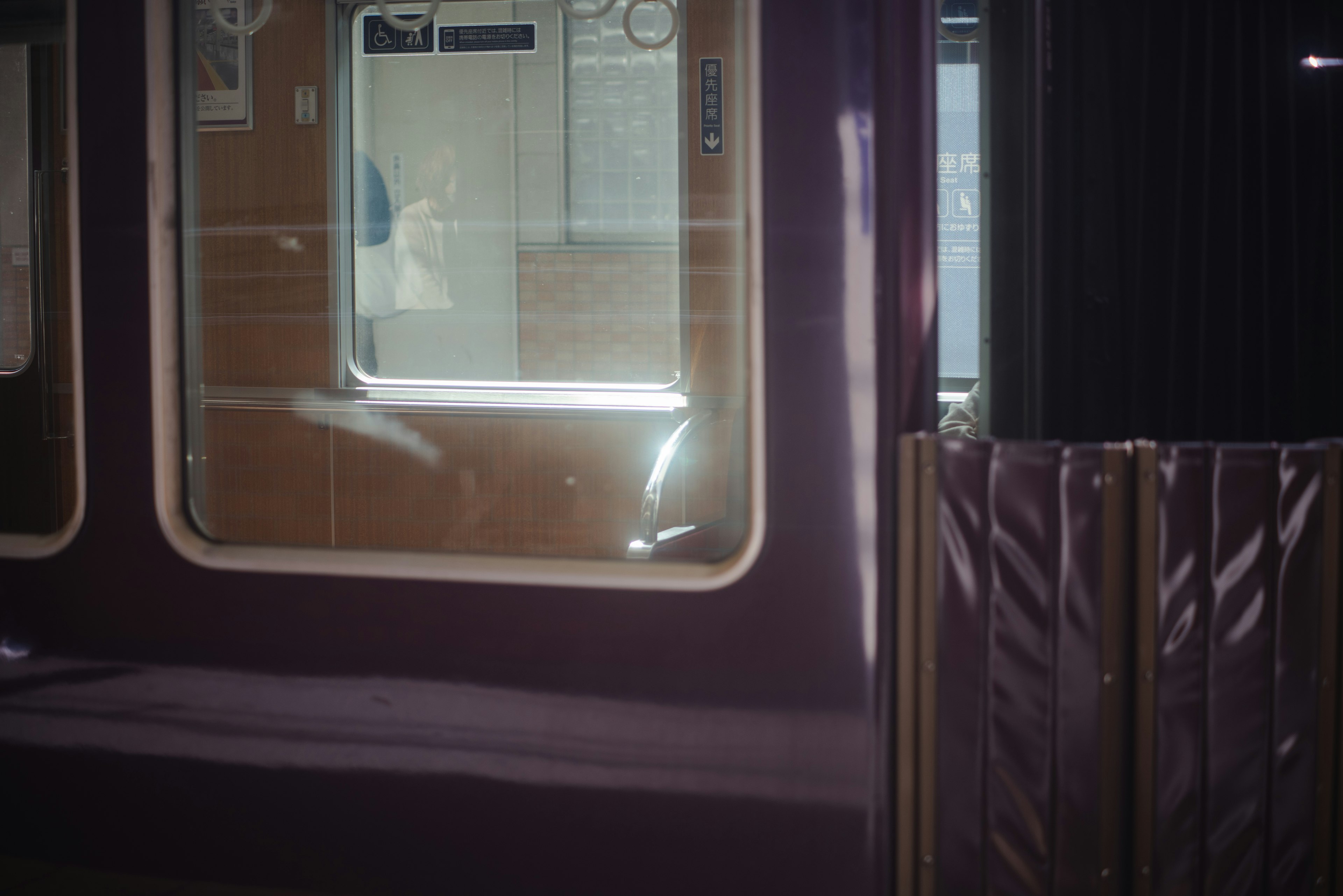 Purple train window reflecting interior elements