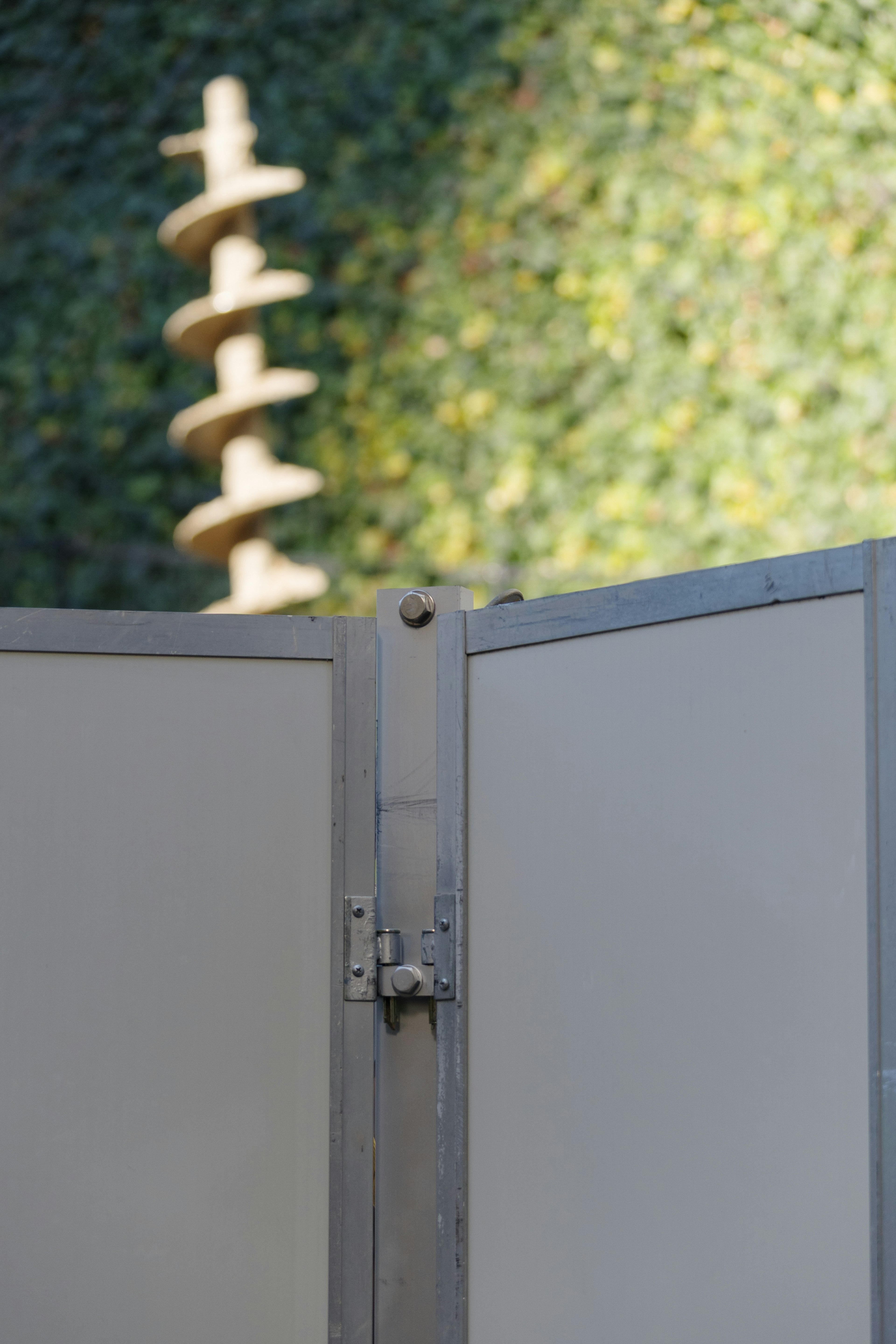 Silver panels with a spiral sculpture in a green background