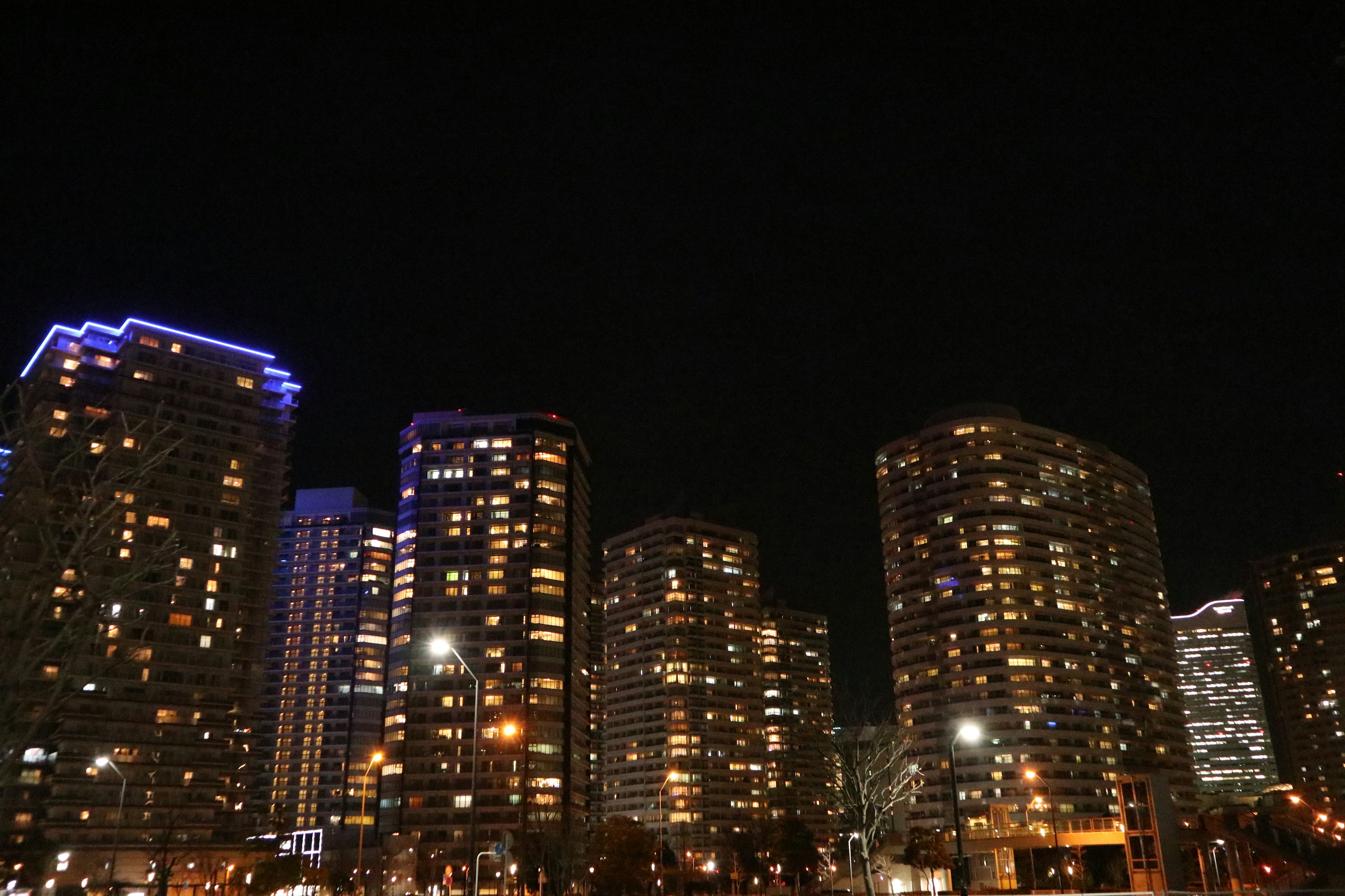 Night view of illuminated skyscrapers with colorful lights