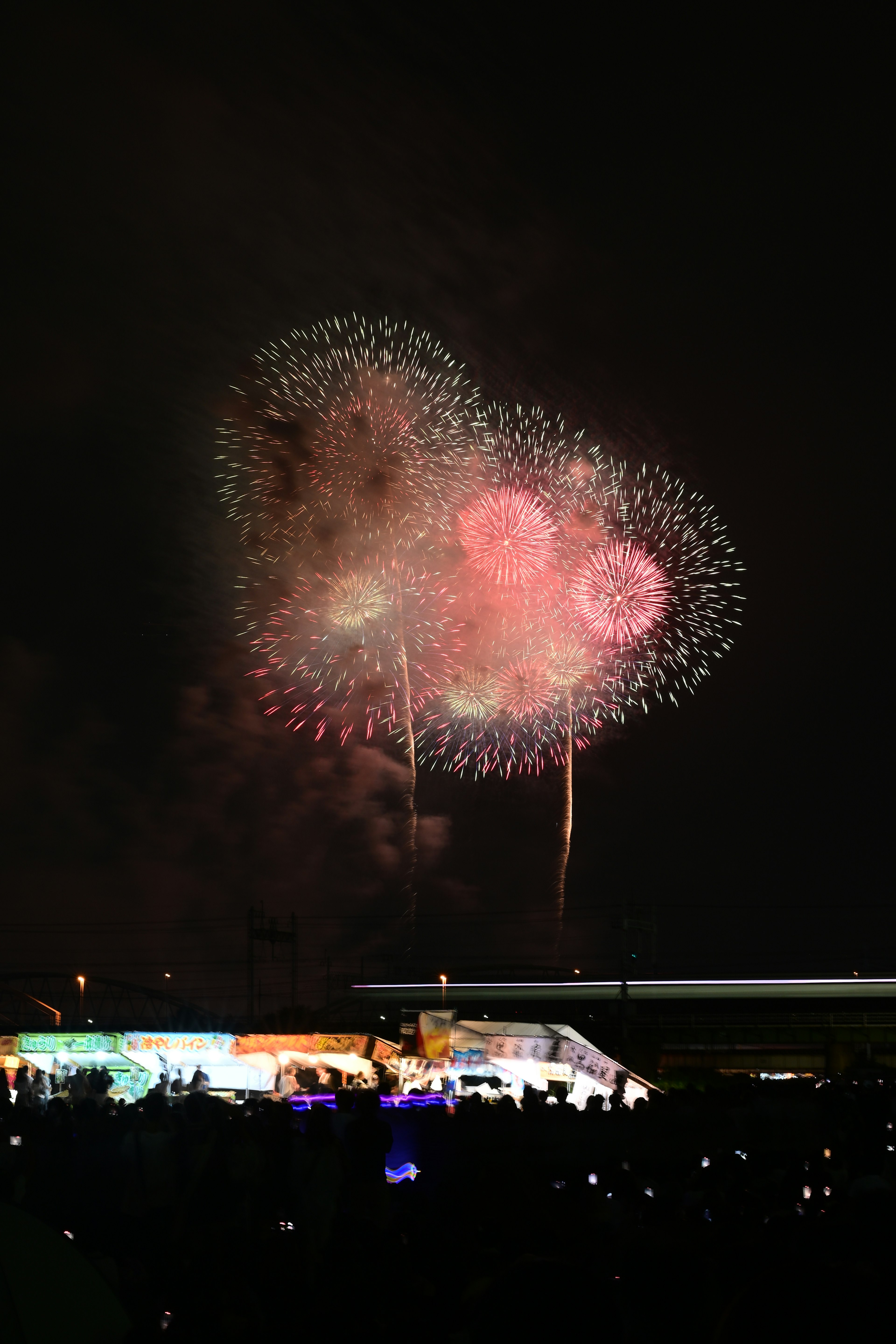 Heart-shaped fireworks illuminate the night sky