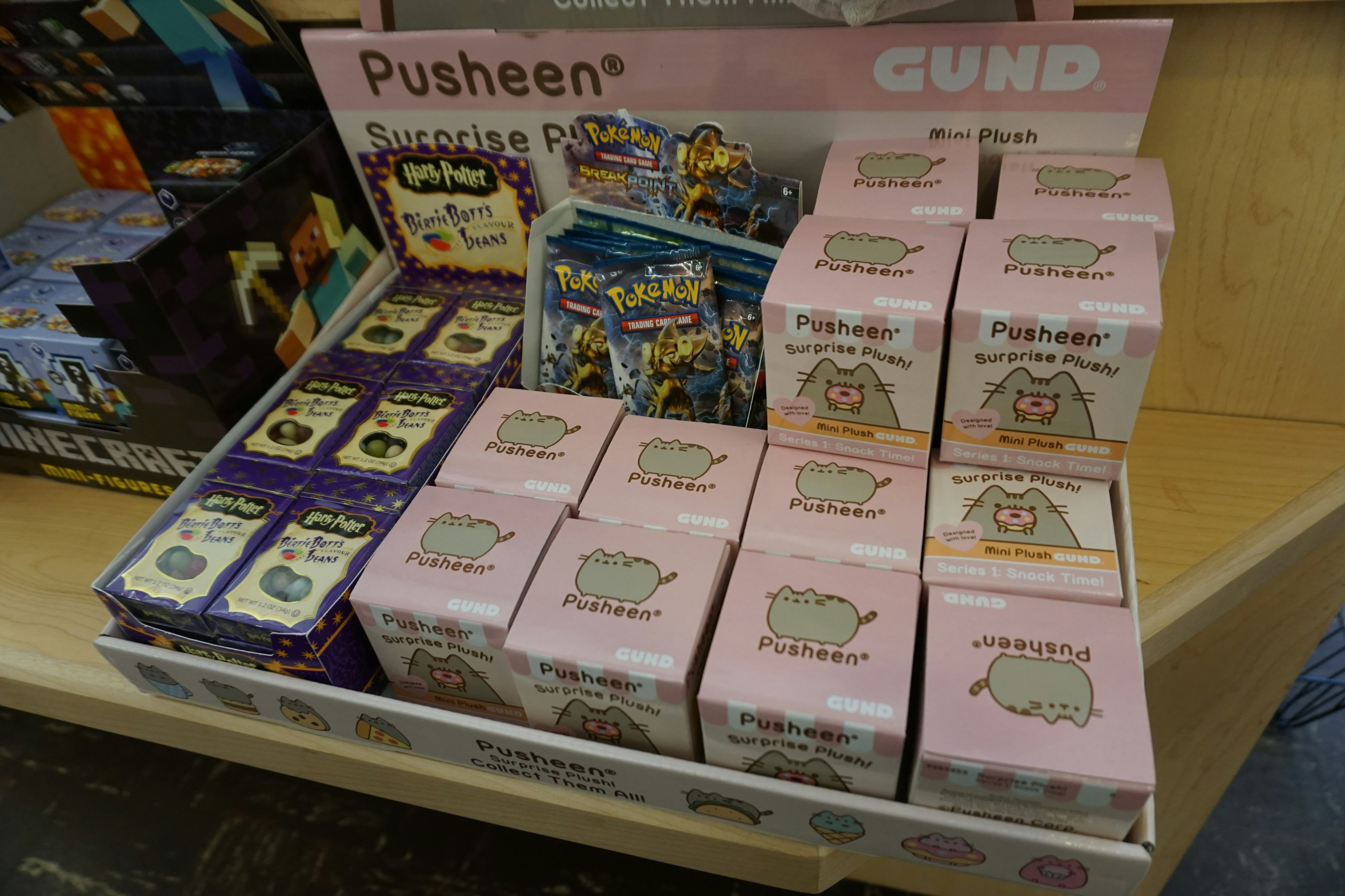 Display of Pusheen plush toys and merchandise on a store shelf