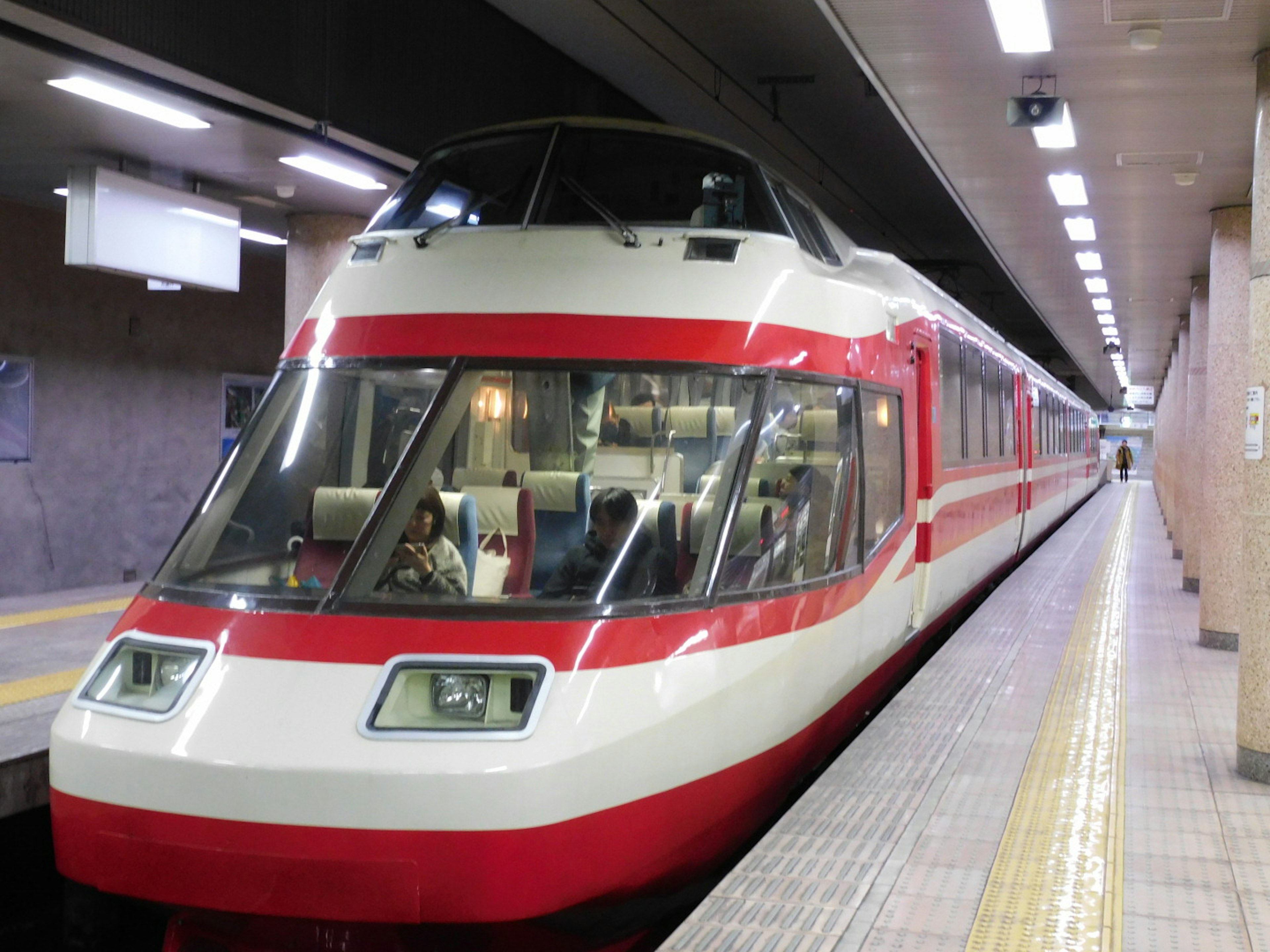 Red and white train at a subway station platform