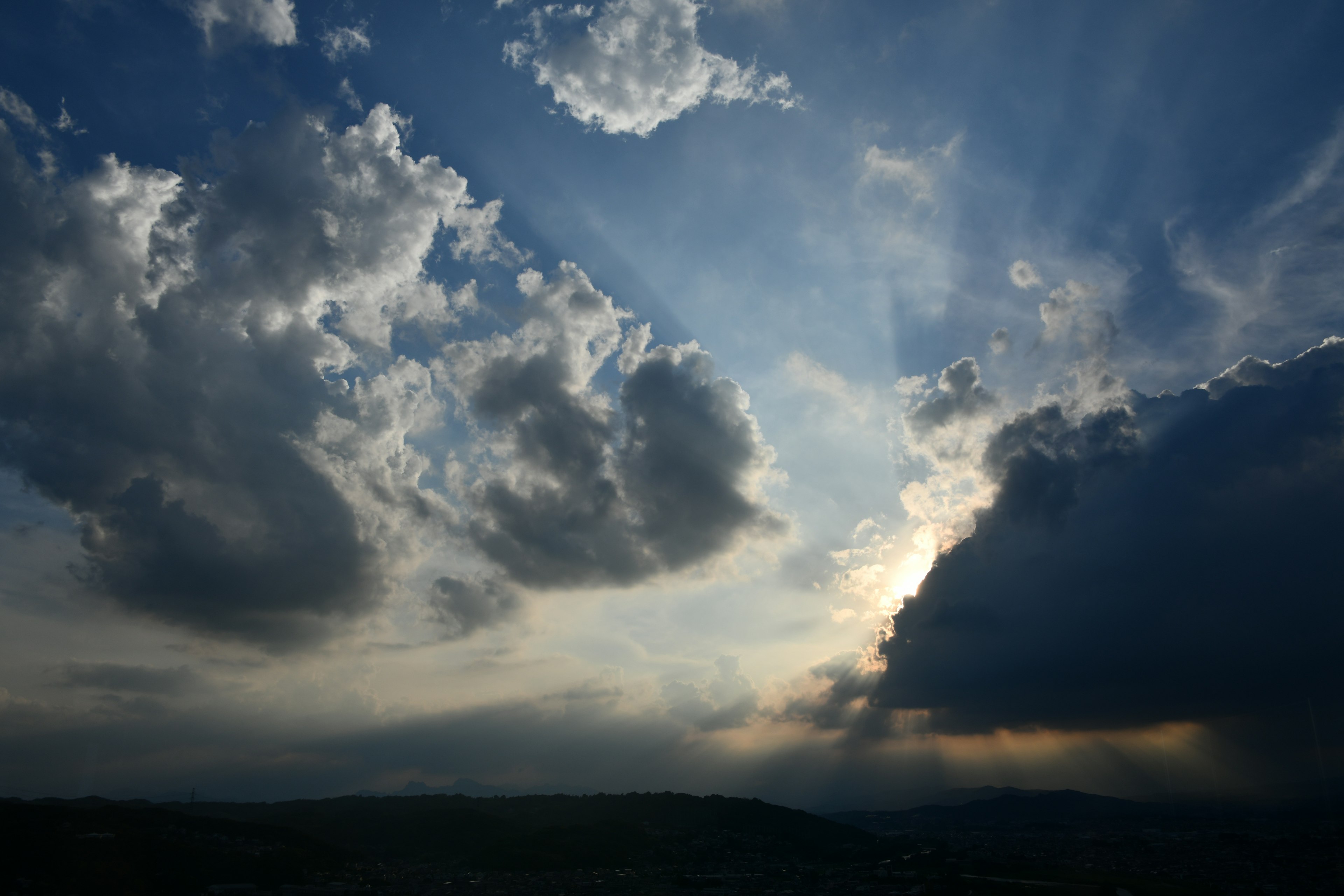 Dramatic sky with clouds and rays of light breaking through