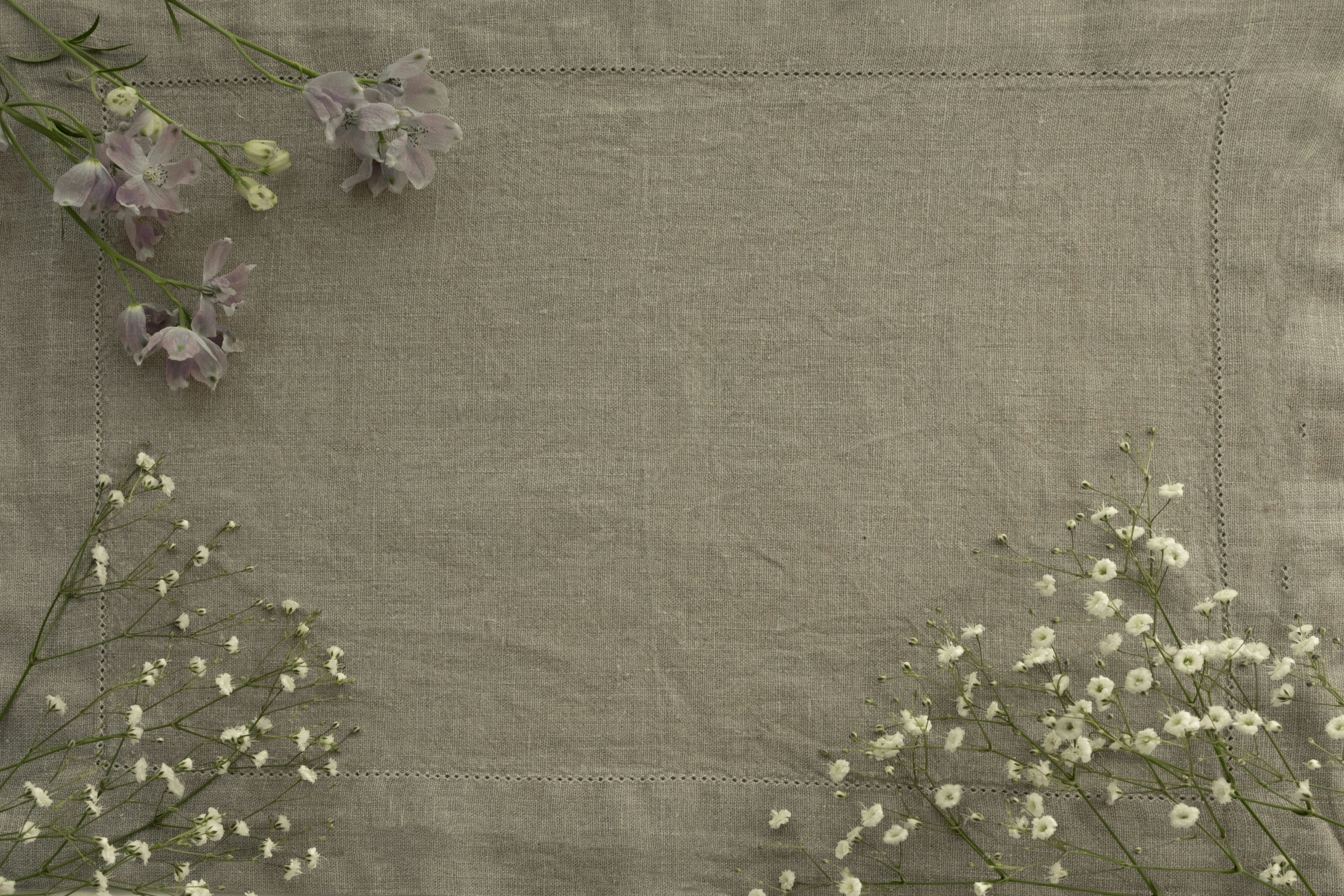 Delicate green fabric with clusters of white flowers and purple blooms