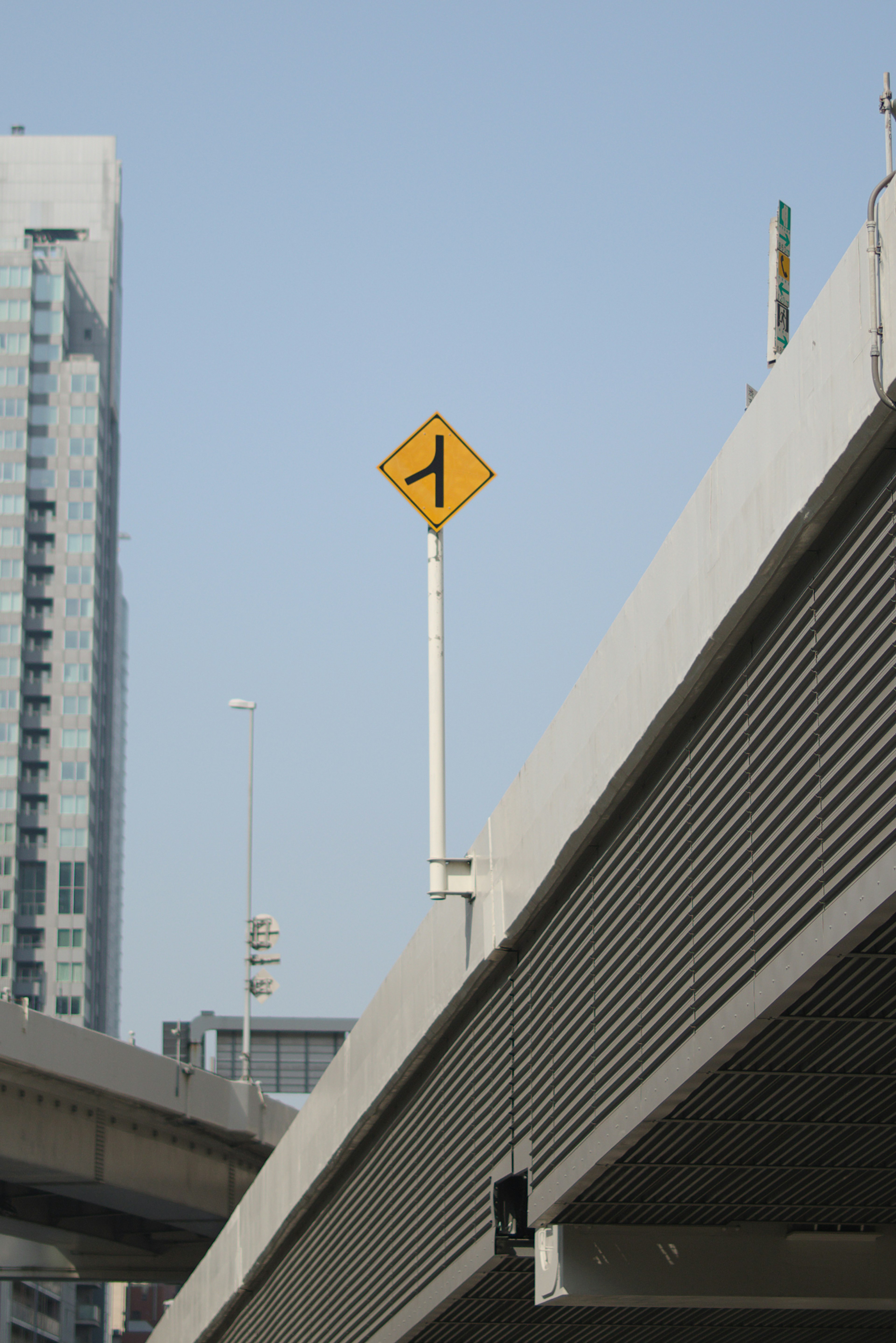 View of an elevated road with a yellow caution sign