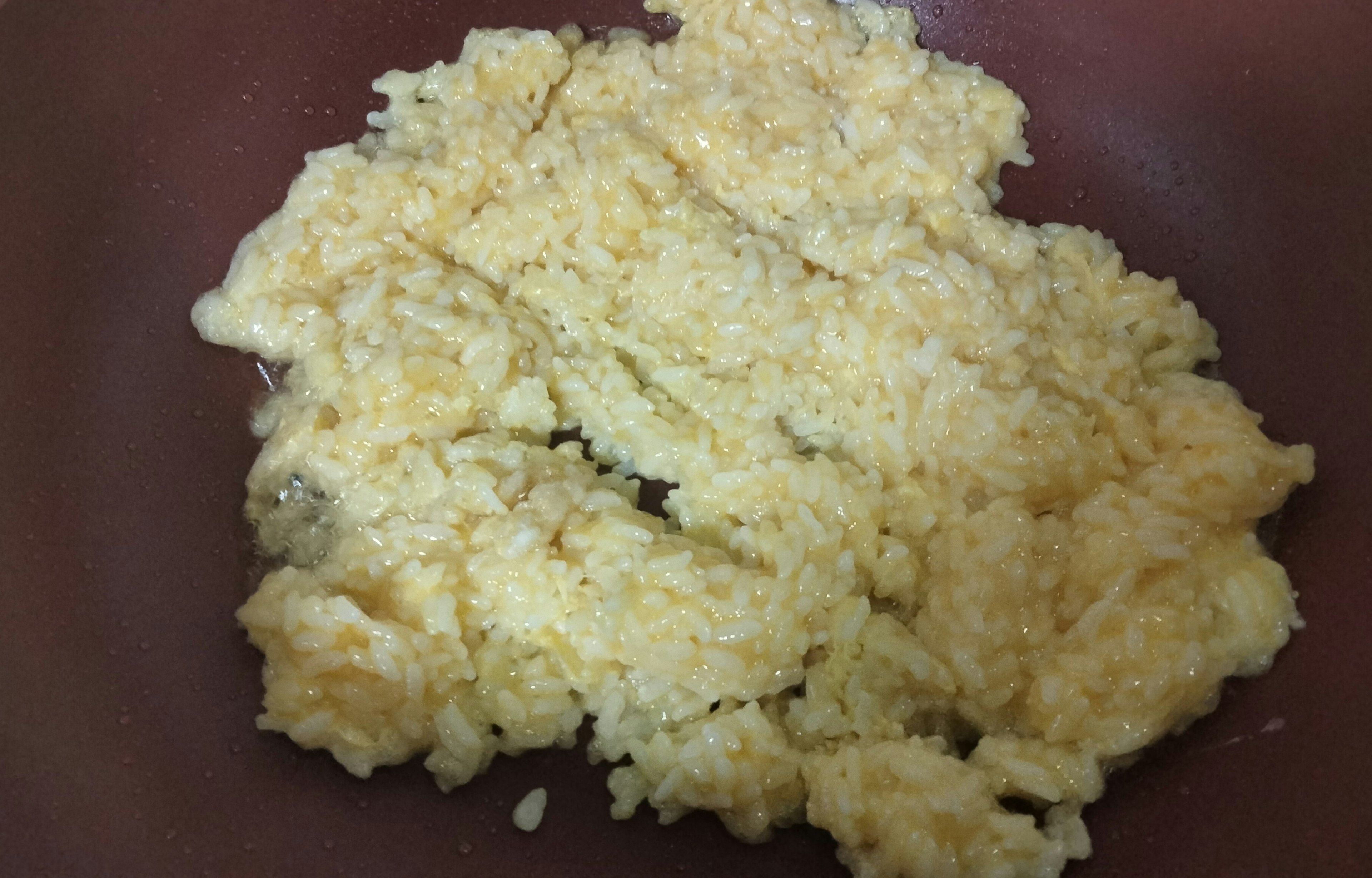 scrambled eggs in a brown bowl