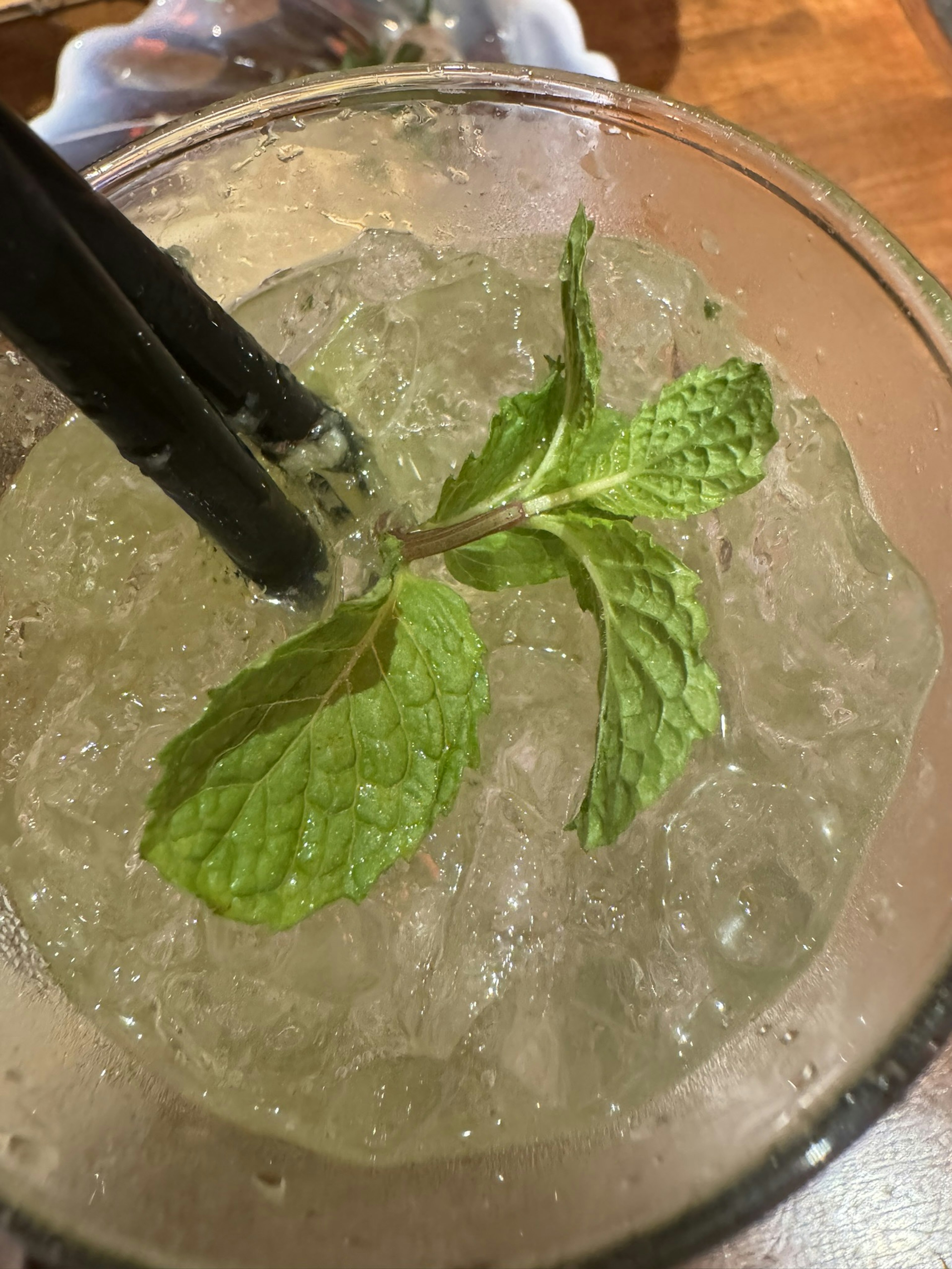 Primer plano de una bebida con hielo y hojas de menta