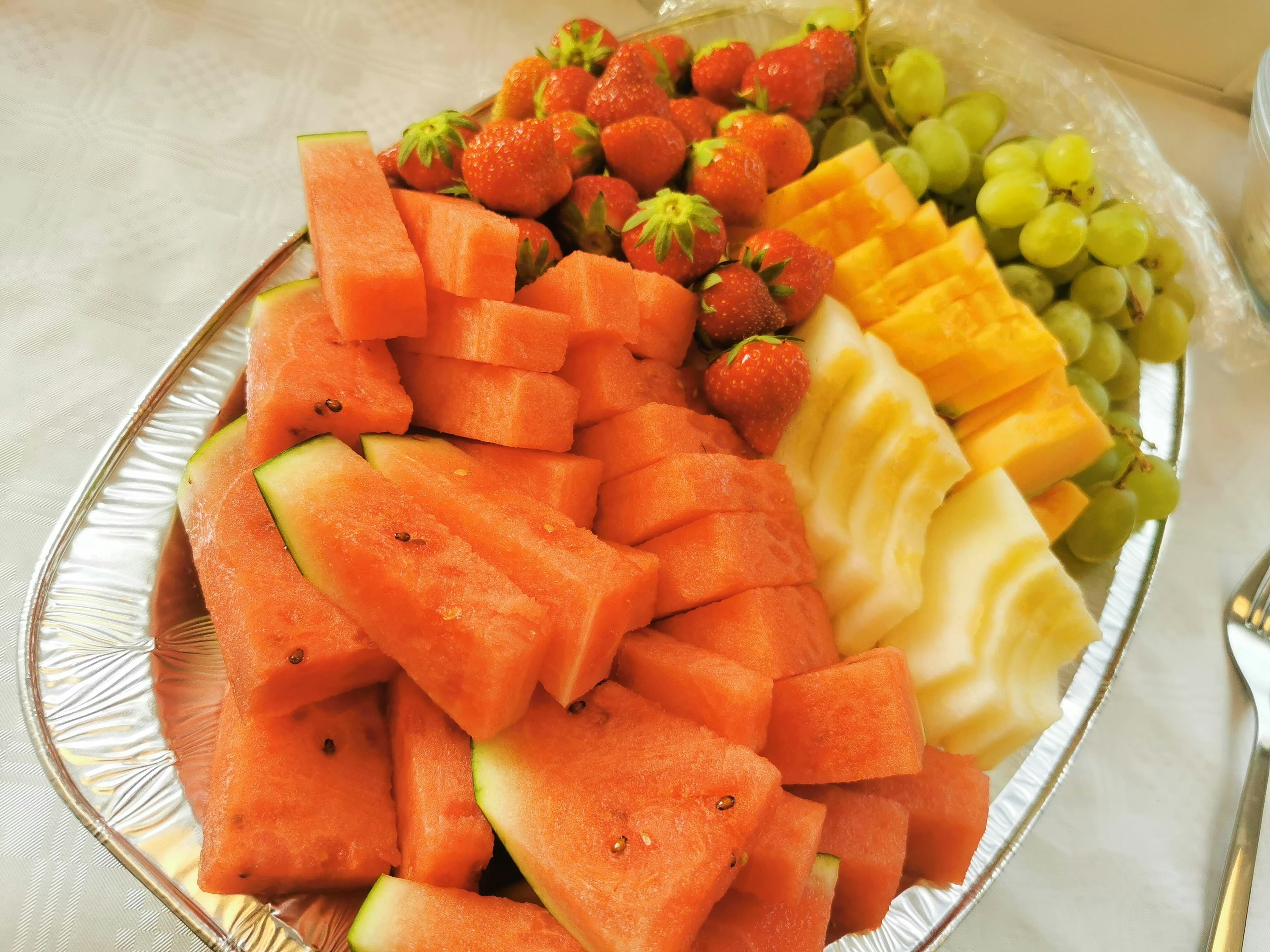 Colorful fruit platter featuring watermelon strawberries melon mango grapes