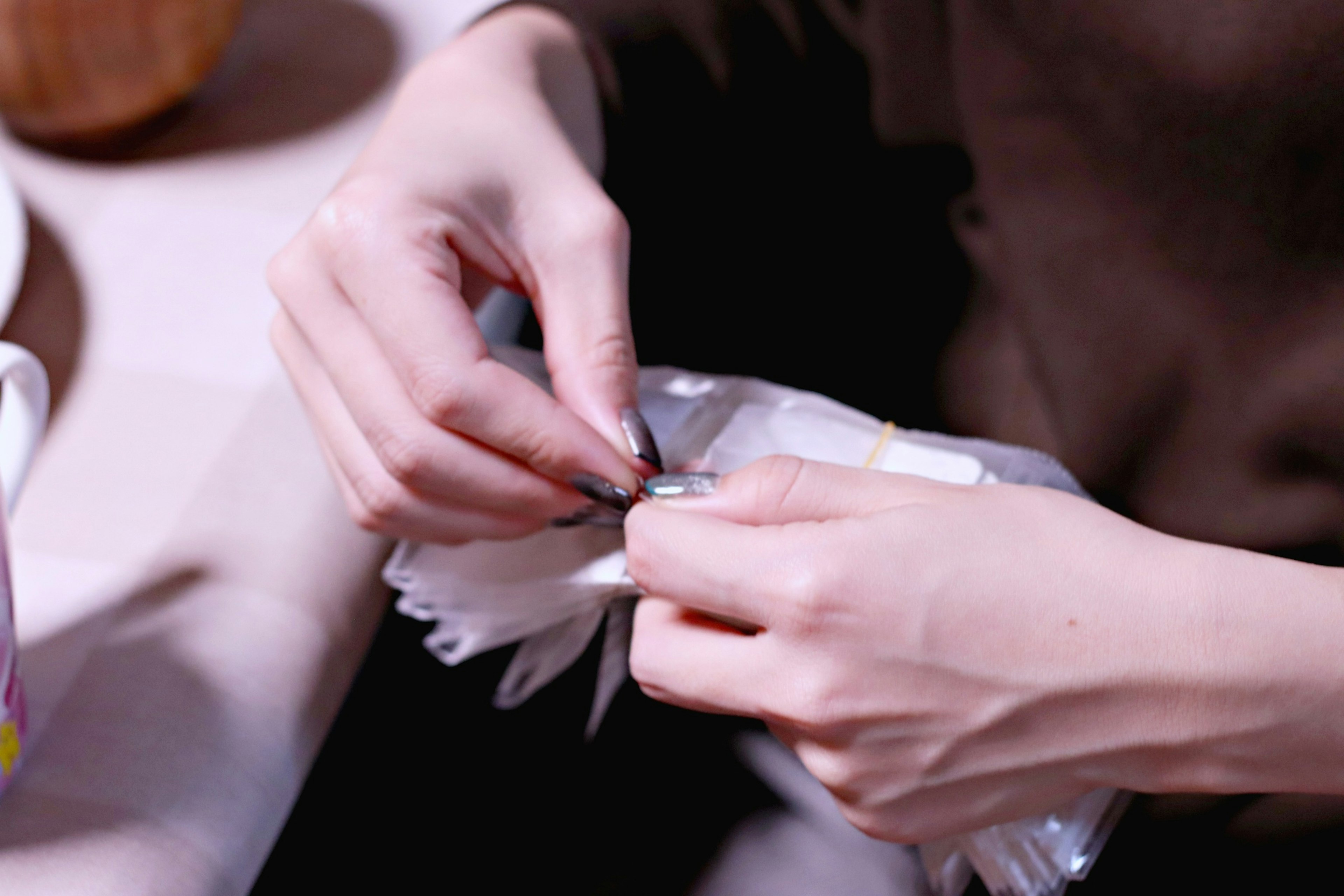 Close-up of a woman's hands handling an object